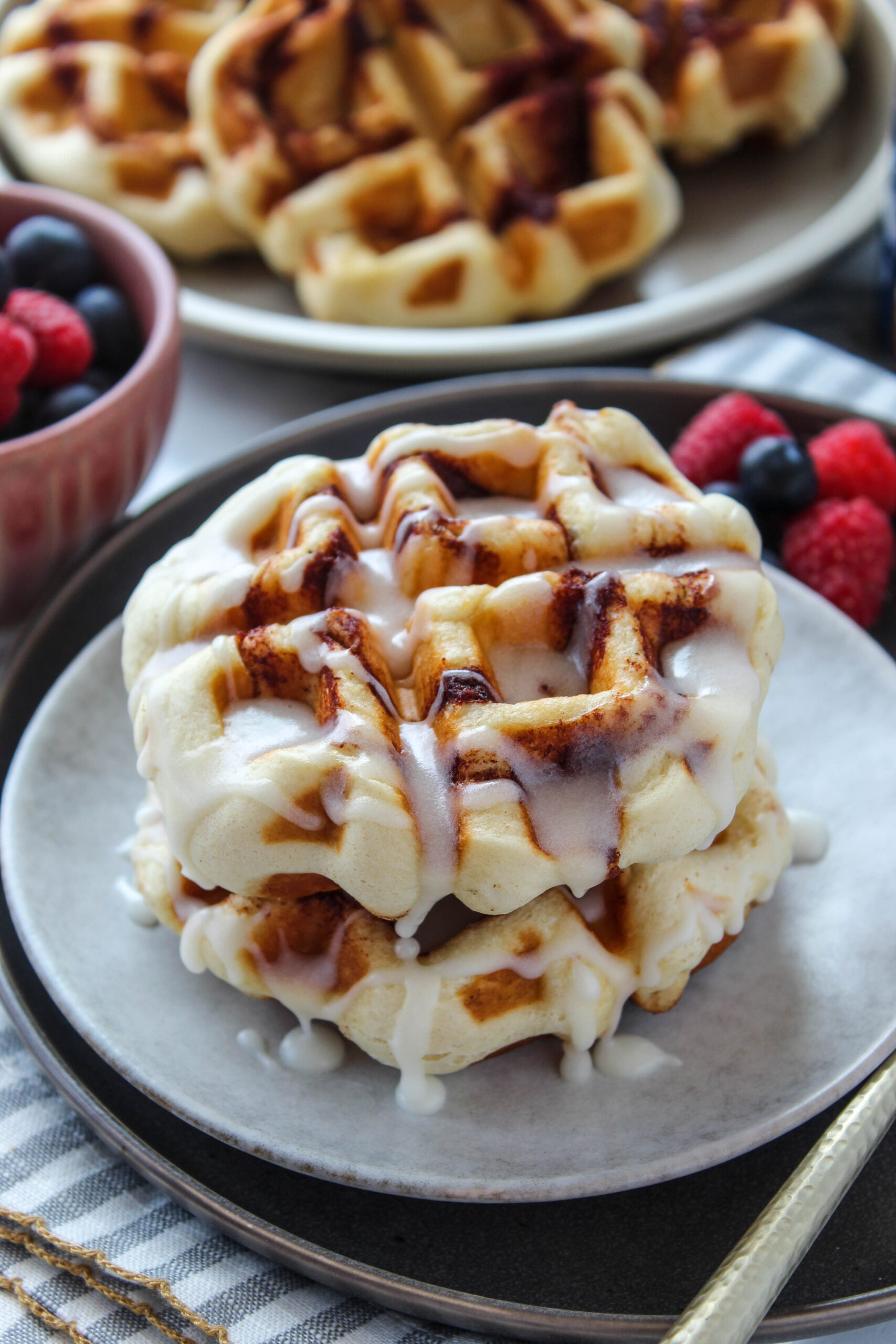 Quick cinnamon roll waffles served warm with vanilla icing