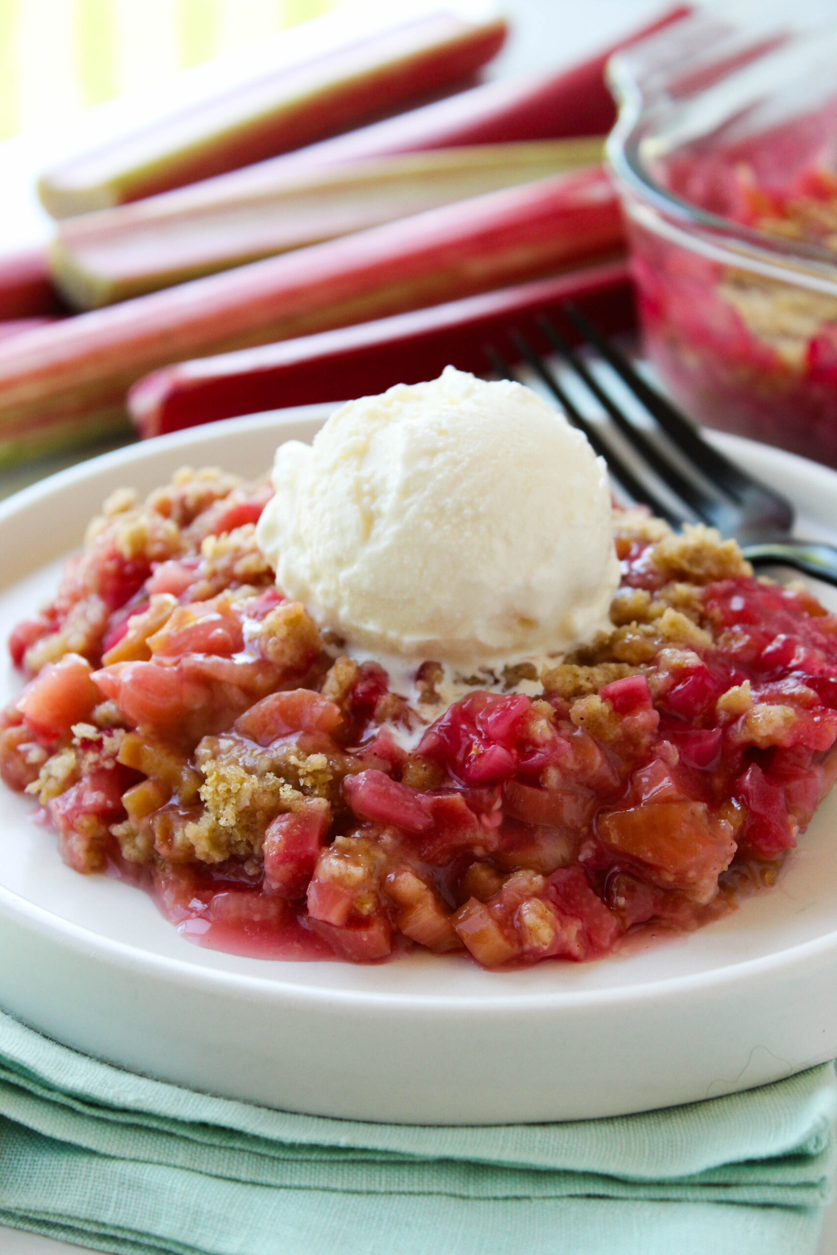 Close‑up of rhubarb crisp showing a jammy filling and crunchy oat crumble