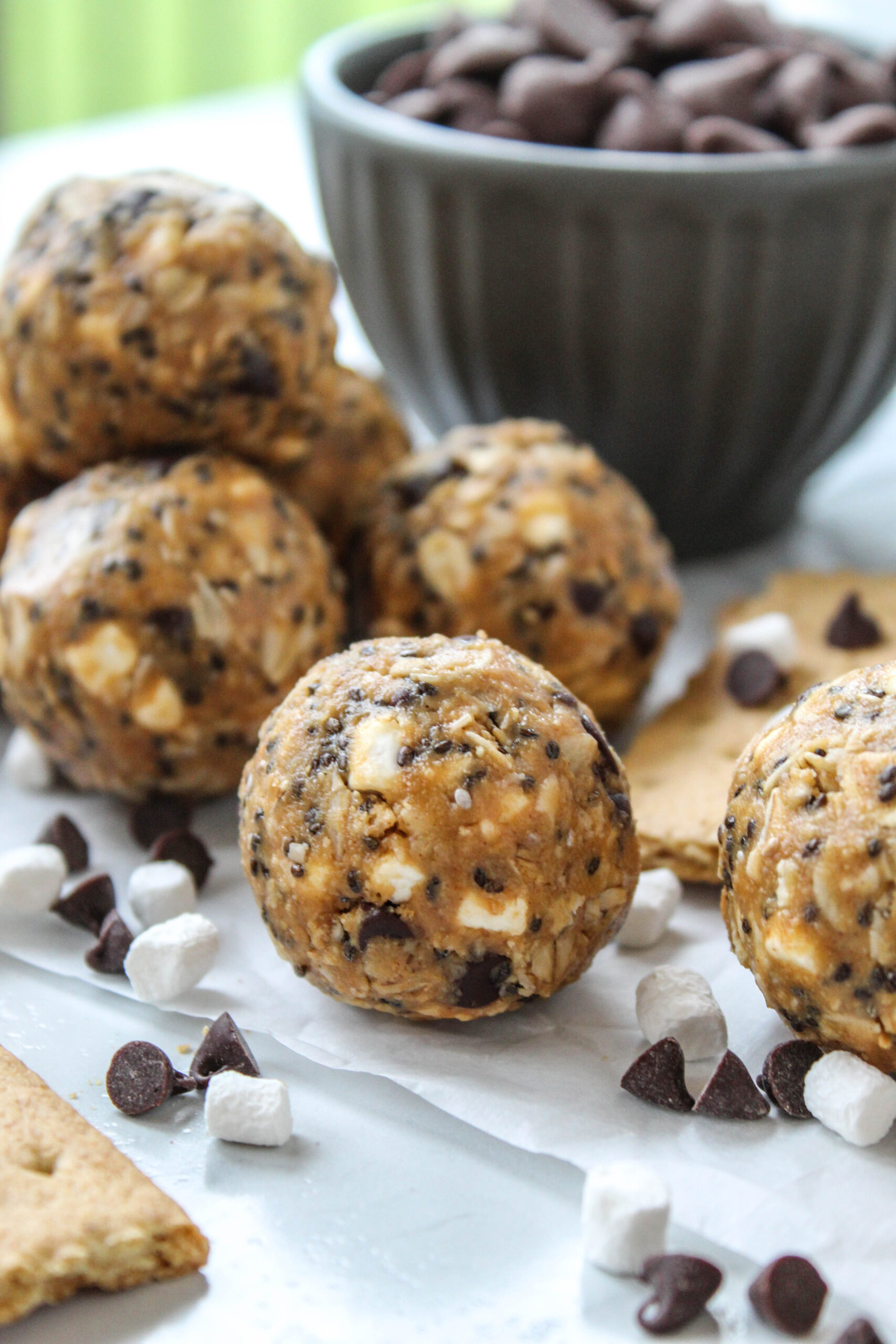 No-bake s’mores energy bites with chocolate, marshmallow pieces, and crushed graham crackers