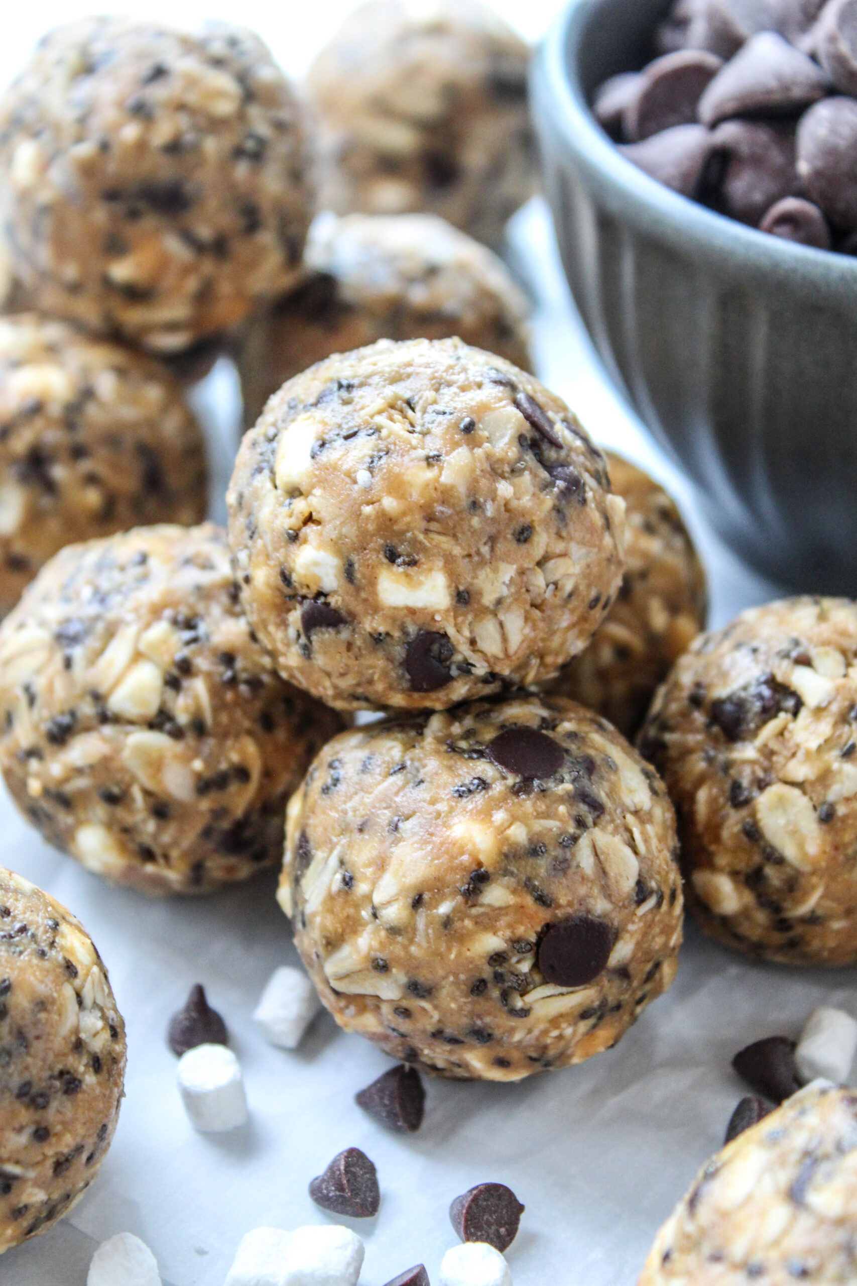 Homemade s’mores energy bites topped with chocolate chips and mini marshmallows for a healthy snack