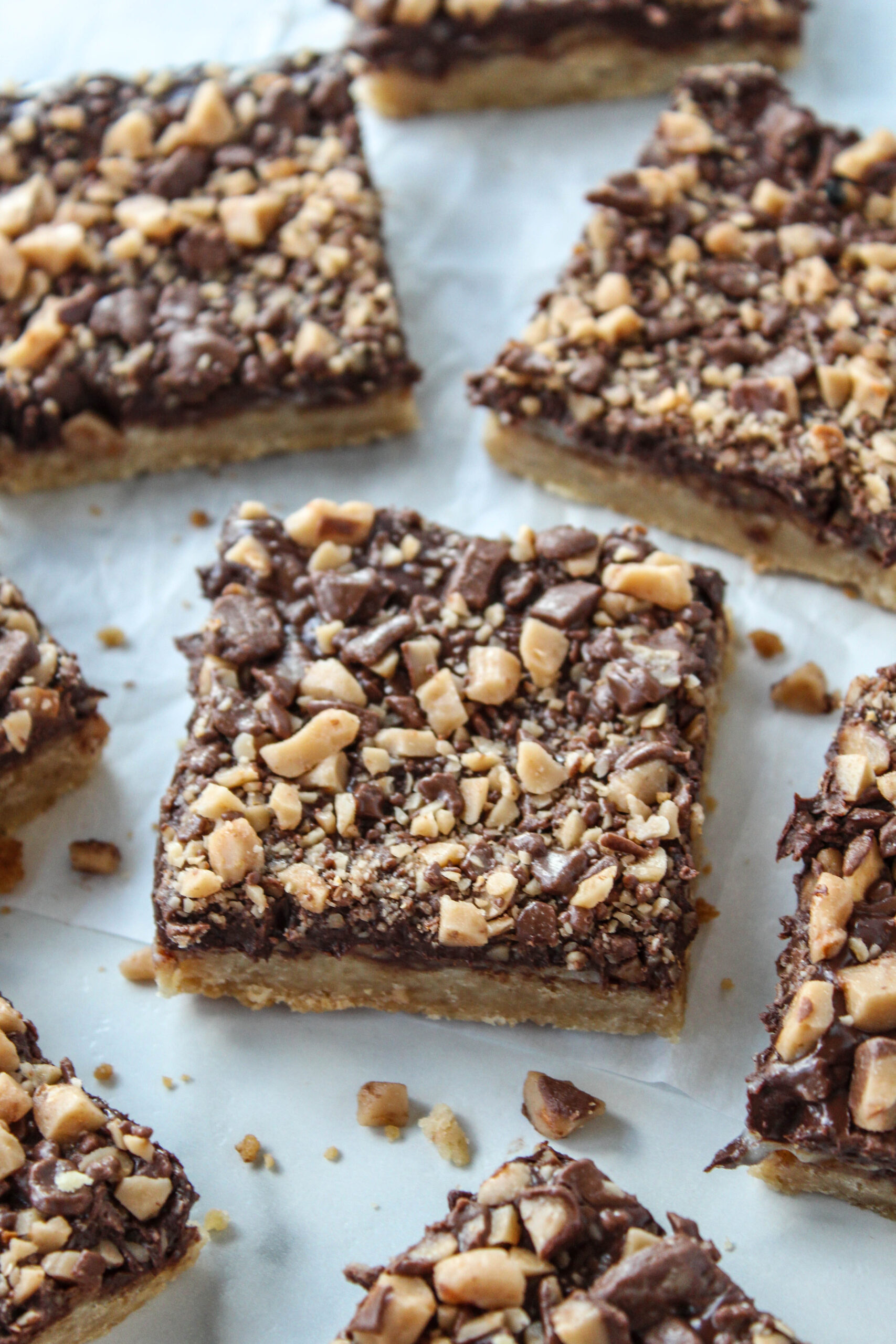 Homemade toffee bars topped with chocolate and toffee bits