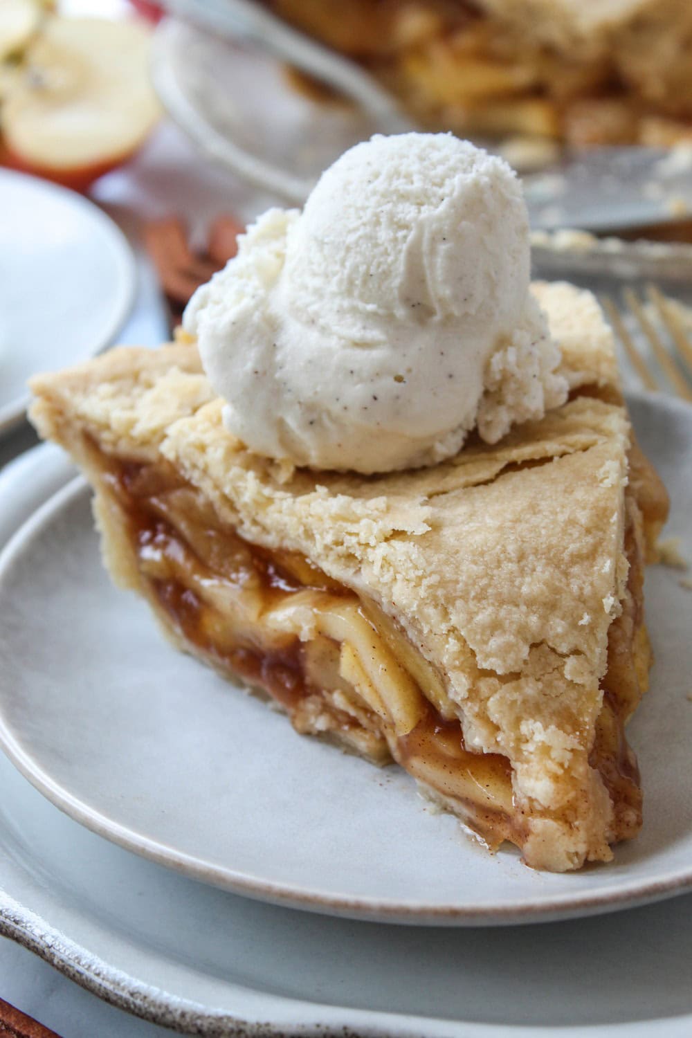 Slice of easy apple pie showing gooey cinnamon apples and flaky layers
