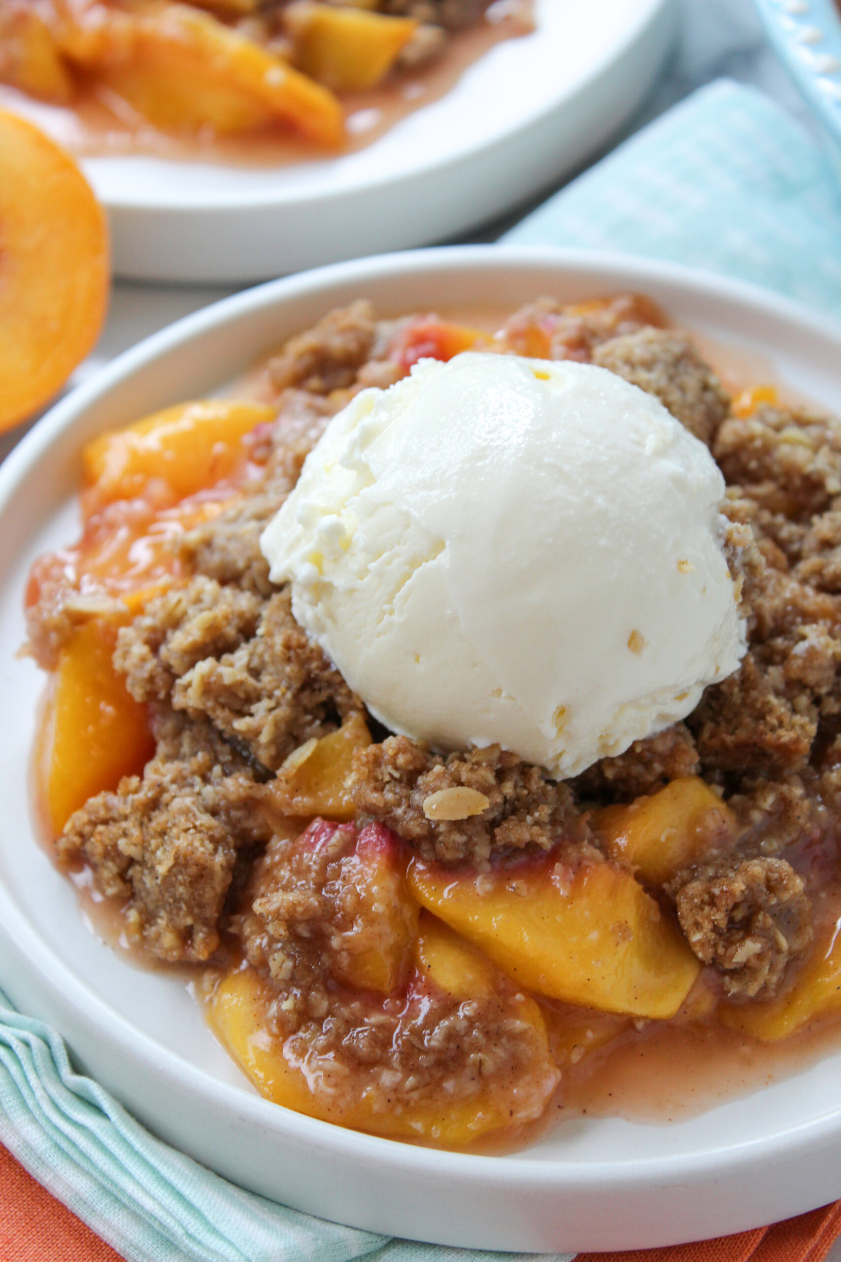 Warm peach crisp fresh from the oven, featuring bubbling peaches and a crisp, buttery crumb topping