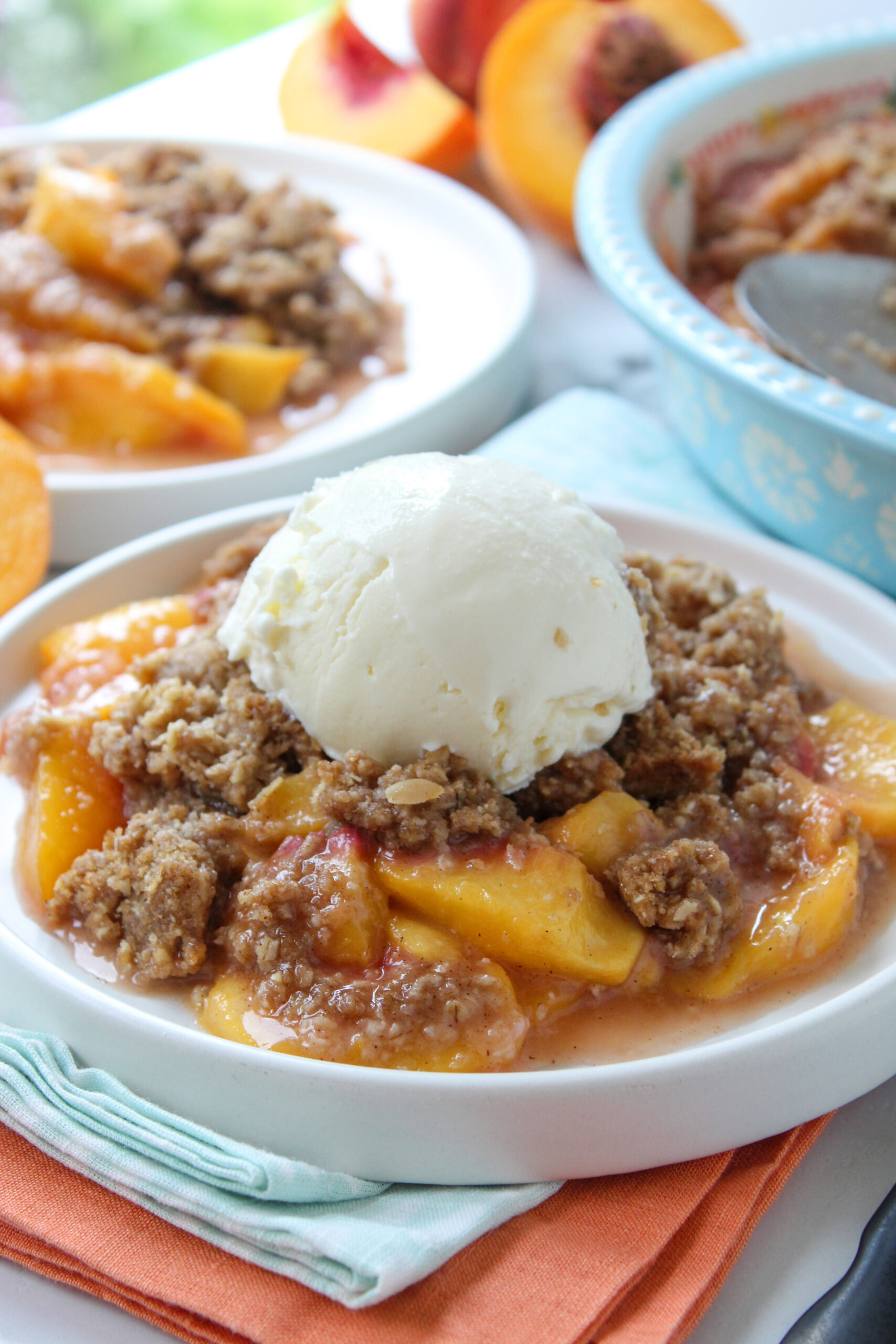 Close-up of a peach crisp with soft, syrupy peaches and a crunchy, golden-brown topping