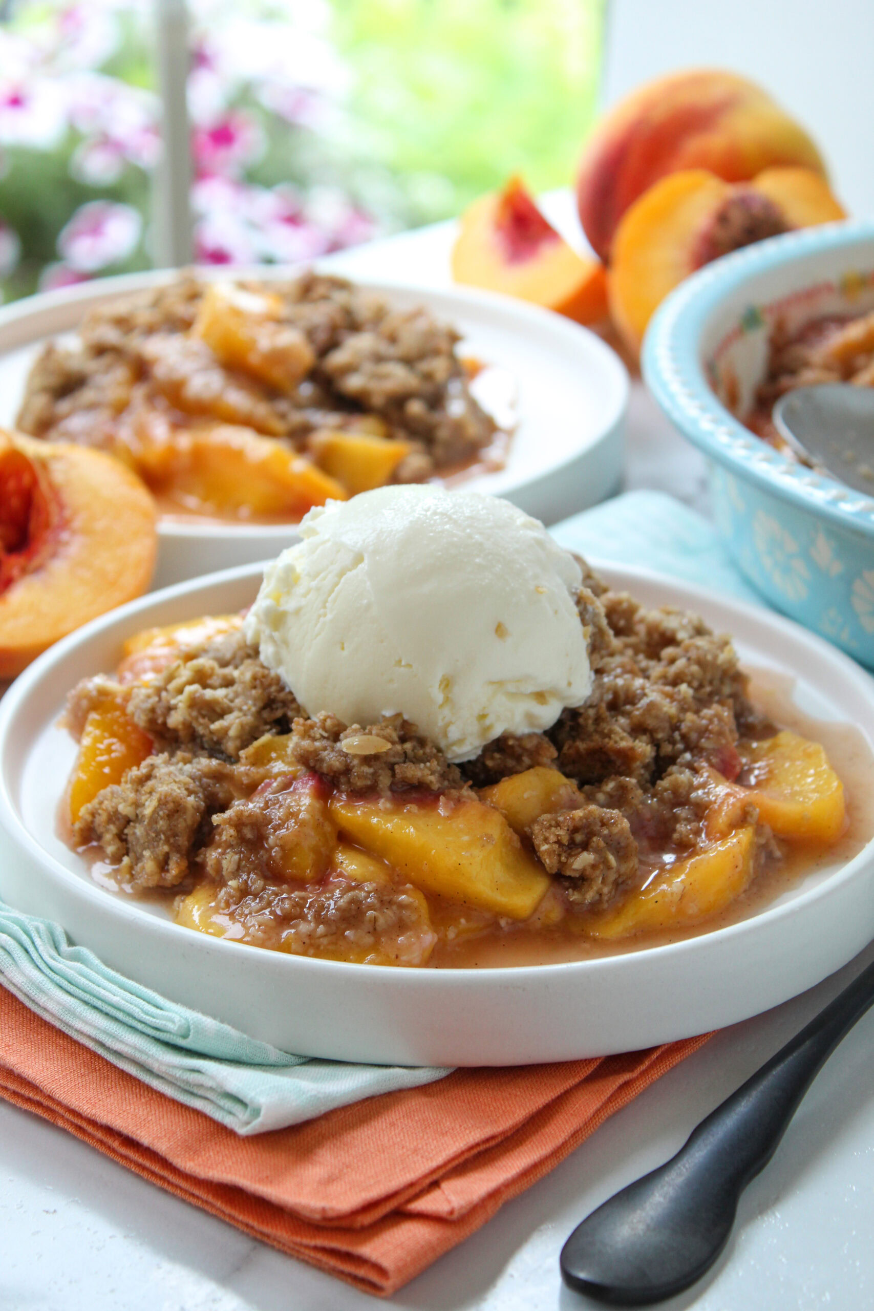 Rustic peach crisp dessert with caramelized peach filling and a crumbly, lightly browned topping