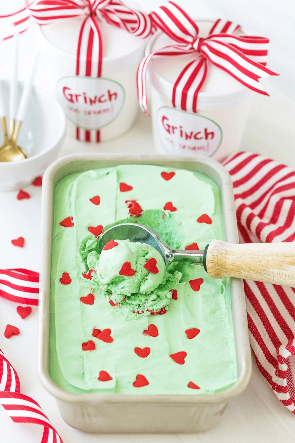 Festive Grinch cupcakes displayed on a dessert tray