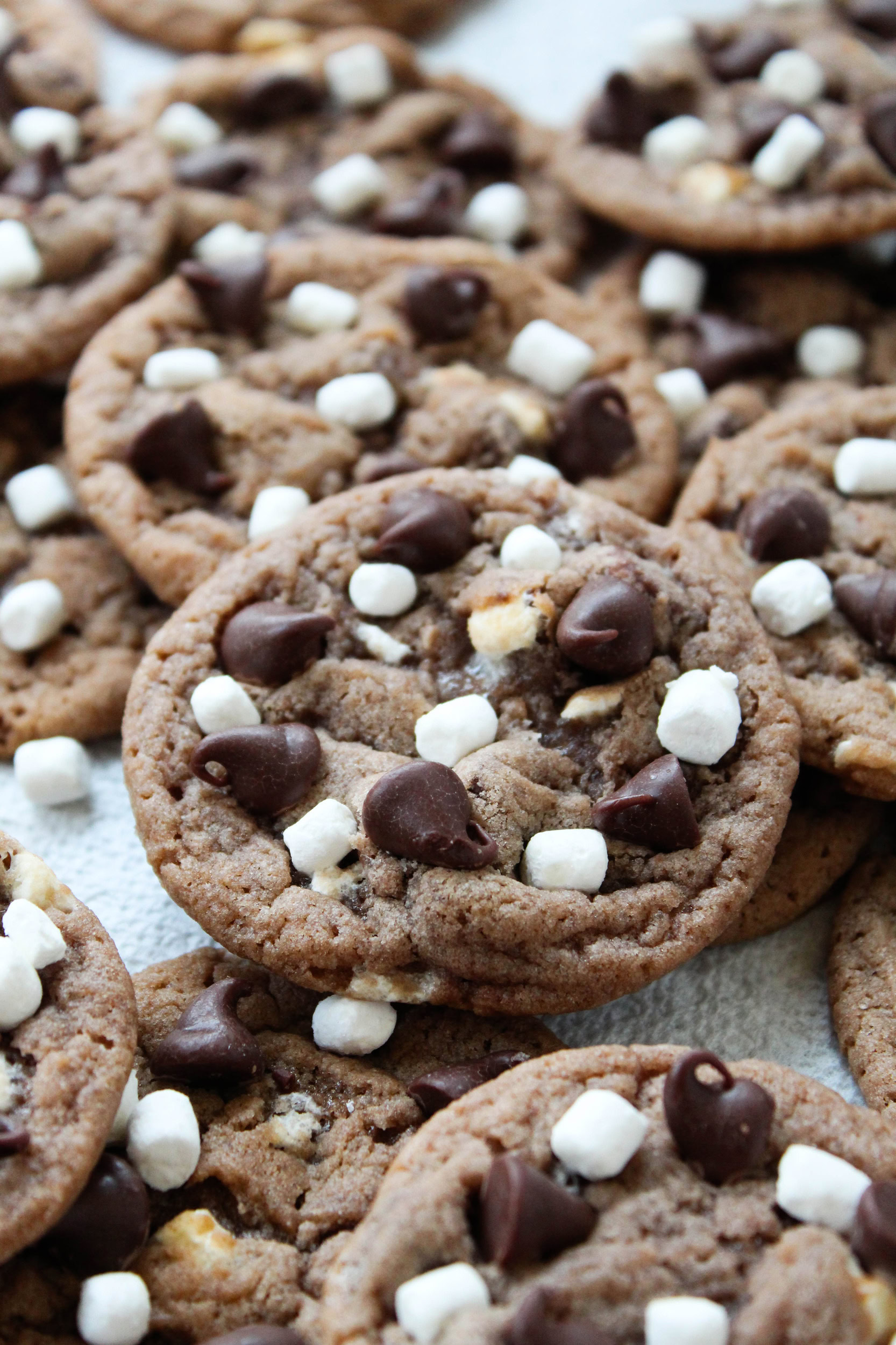 Thin hot cocoa cookies stacked to show chewy‑thin texture