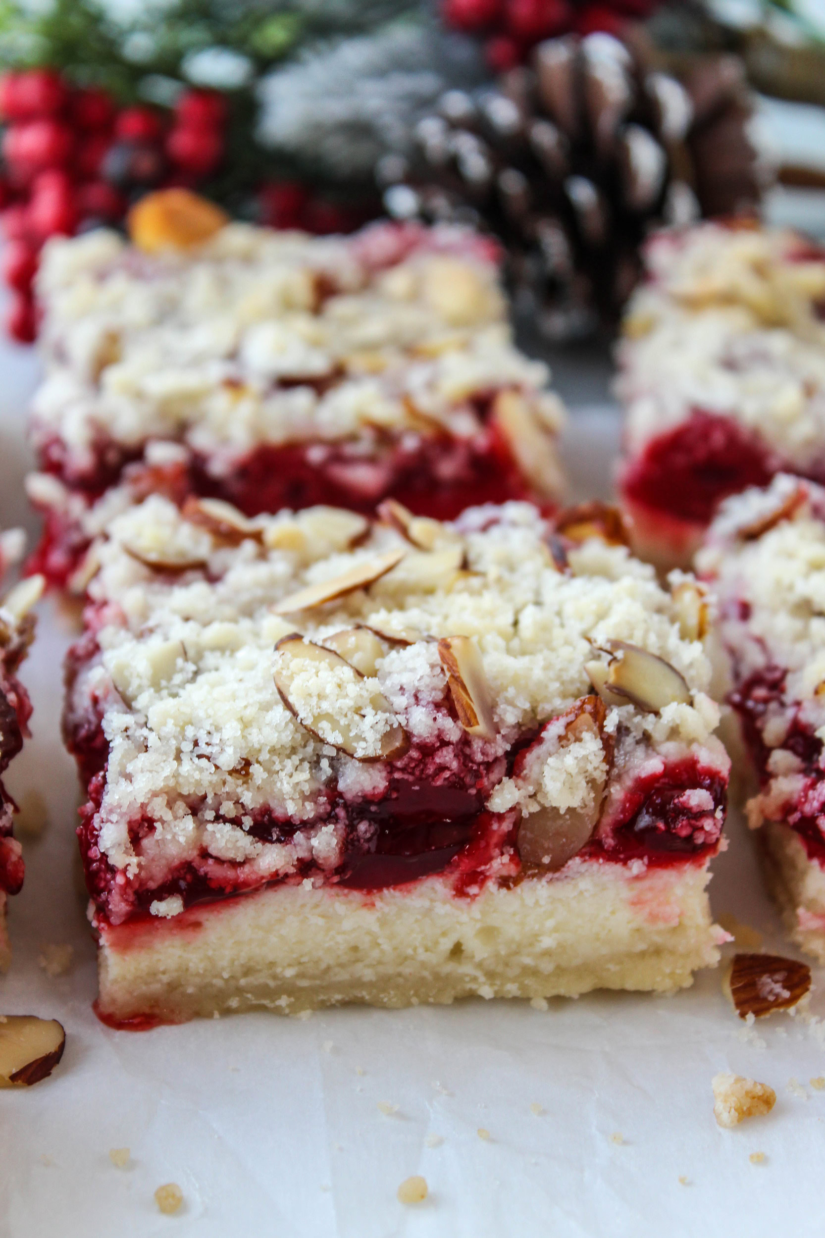Holiday cheesecake bars recipe served on a festive Christmas dessert tray.