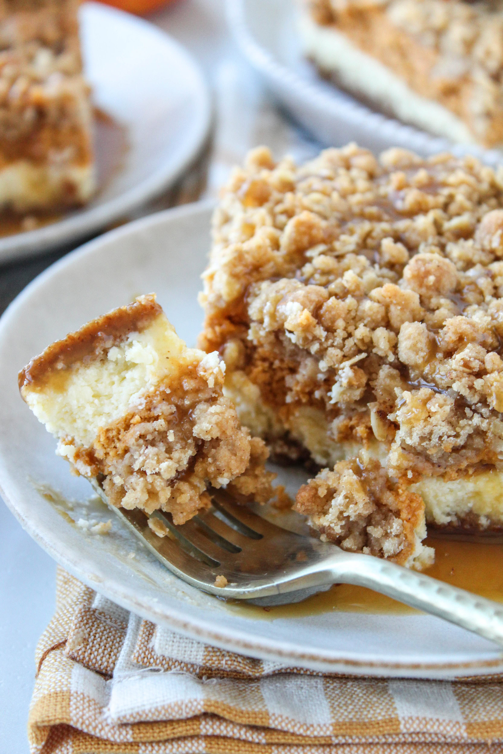 Creamy pumpkin cheesecake bars with a buttery crust and caramel topping