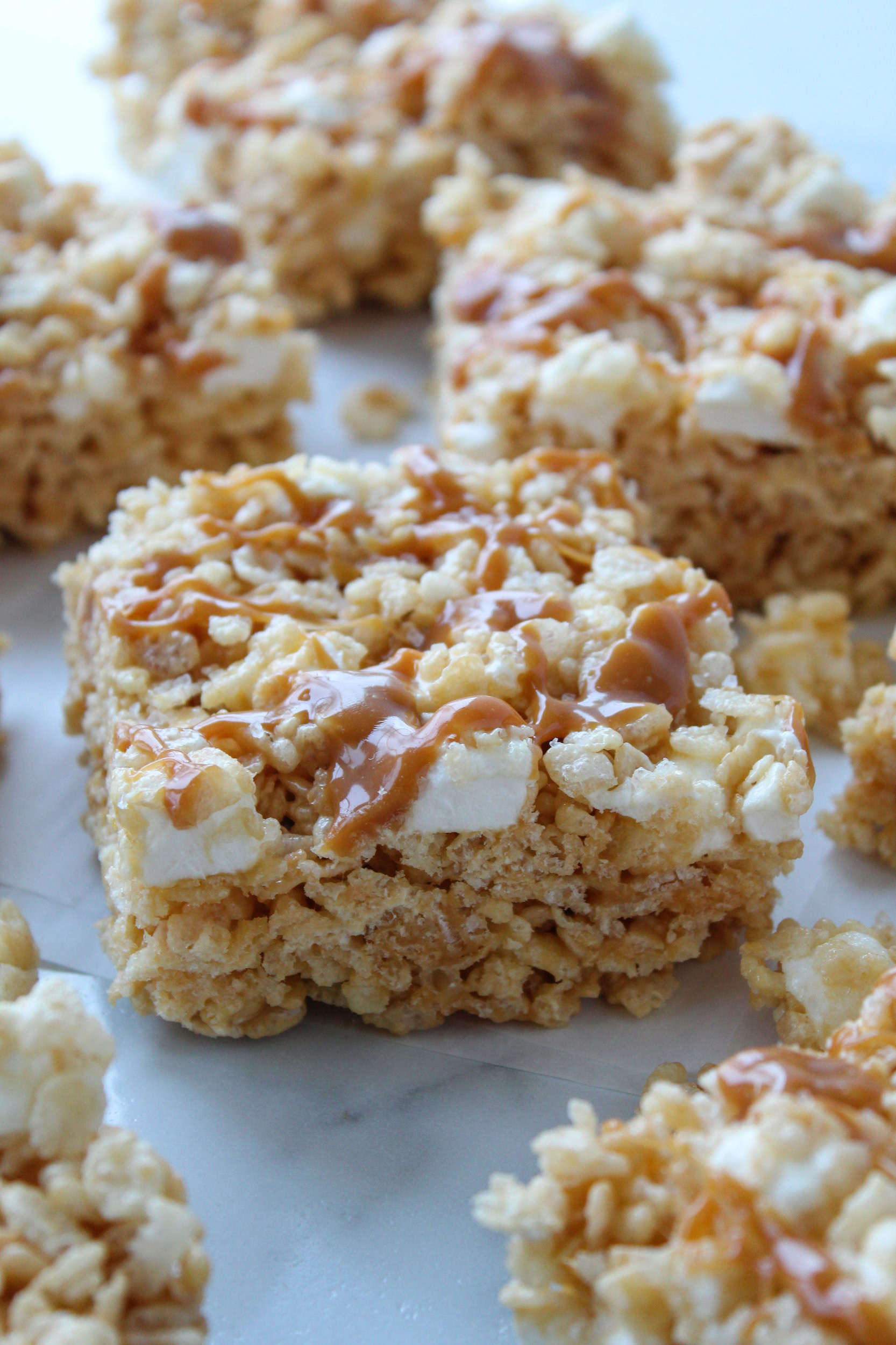 Caramel rice krispie treats with a gooey caramel layer and crispy cereal