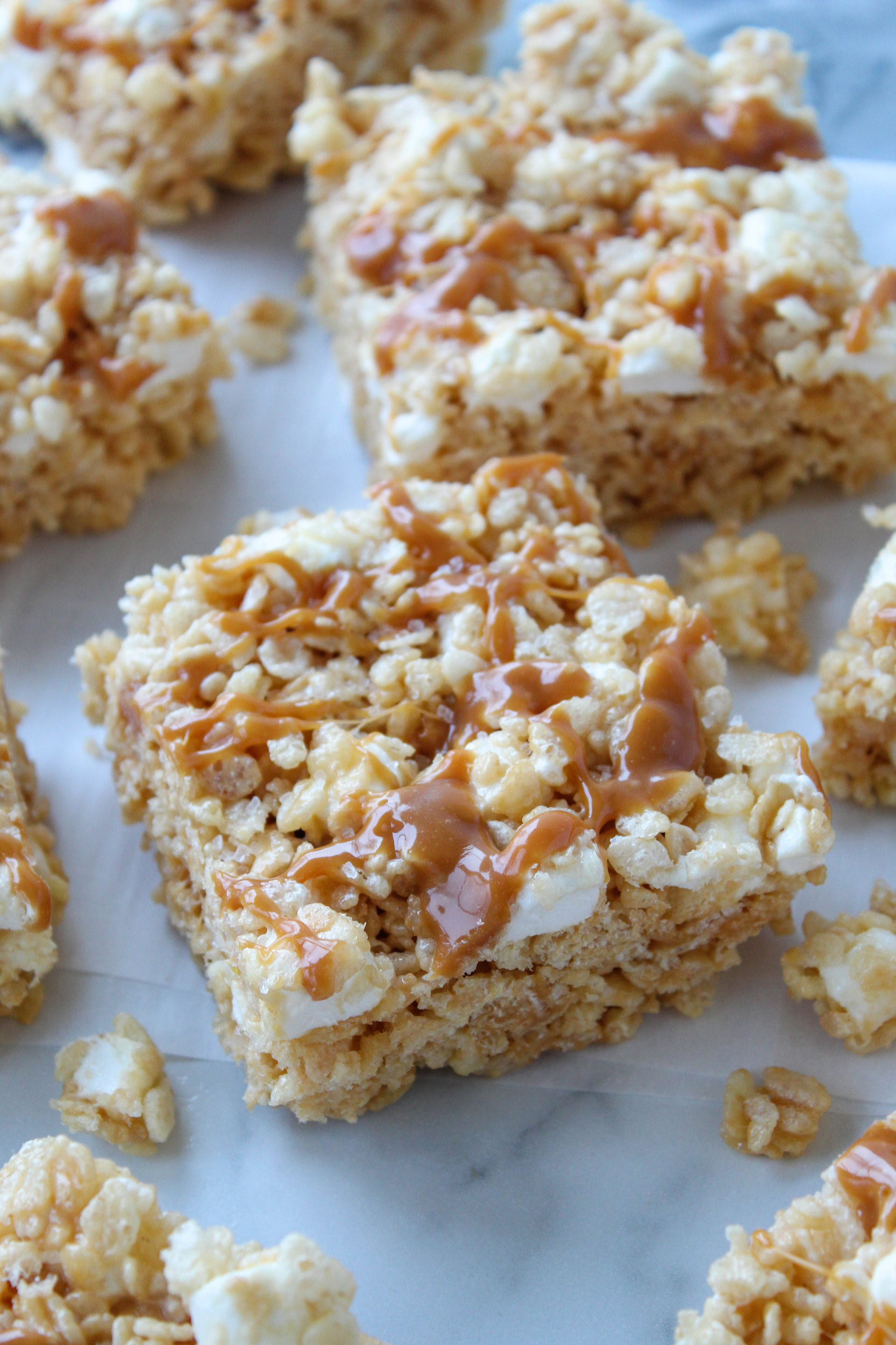 Salted caramel rice krispie treats topped with caramel drizzle