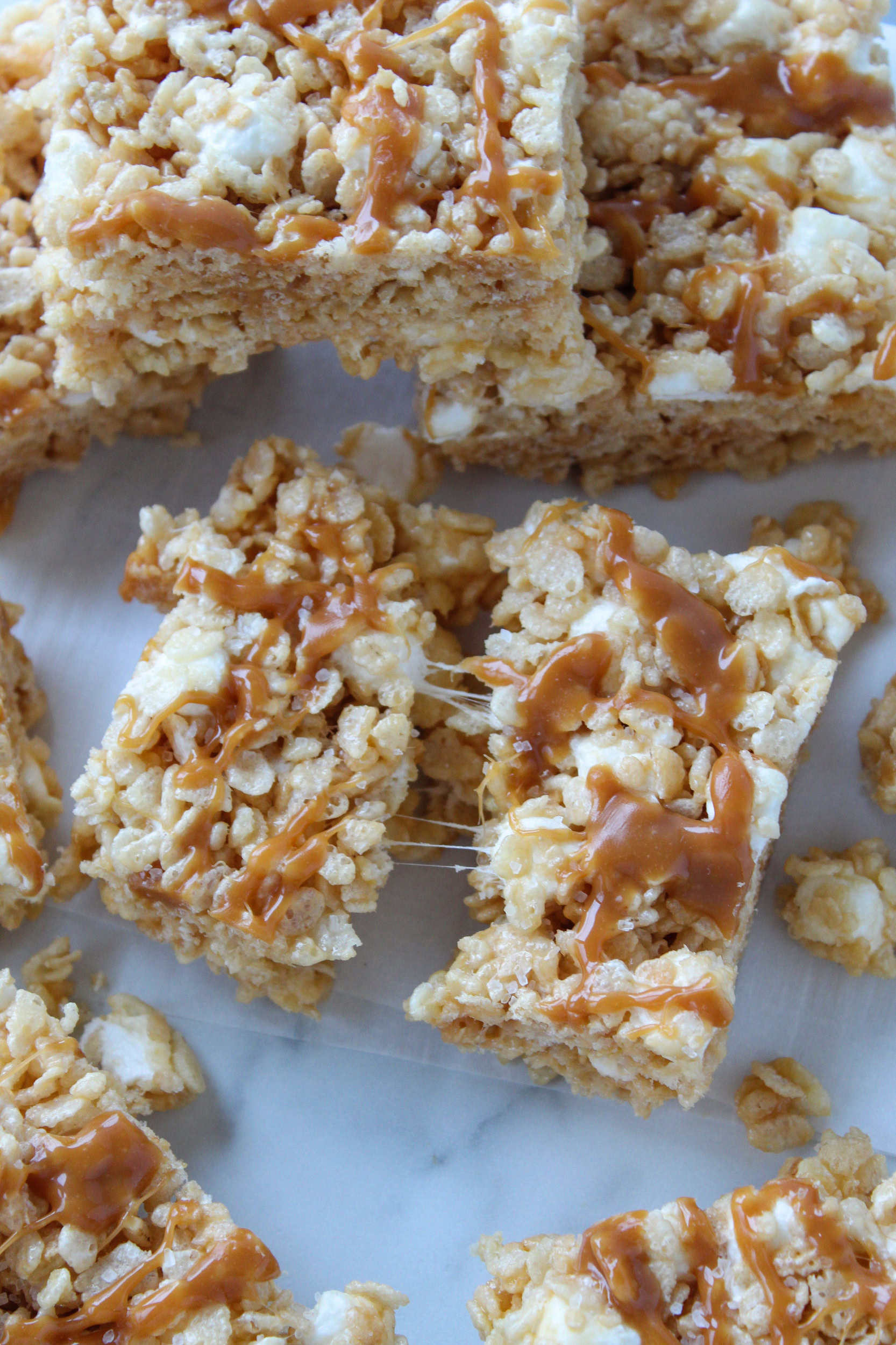 Close‑up of chewy caramel rice krispie treats showing crunchy cereal and caramel