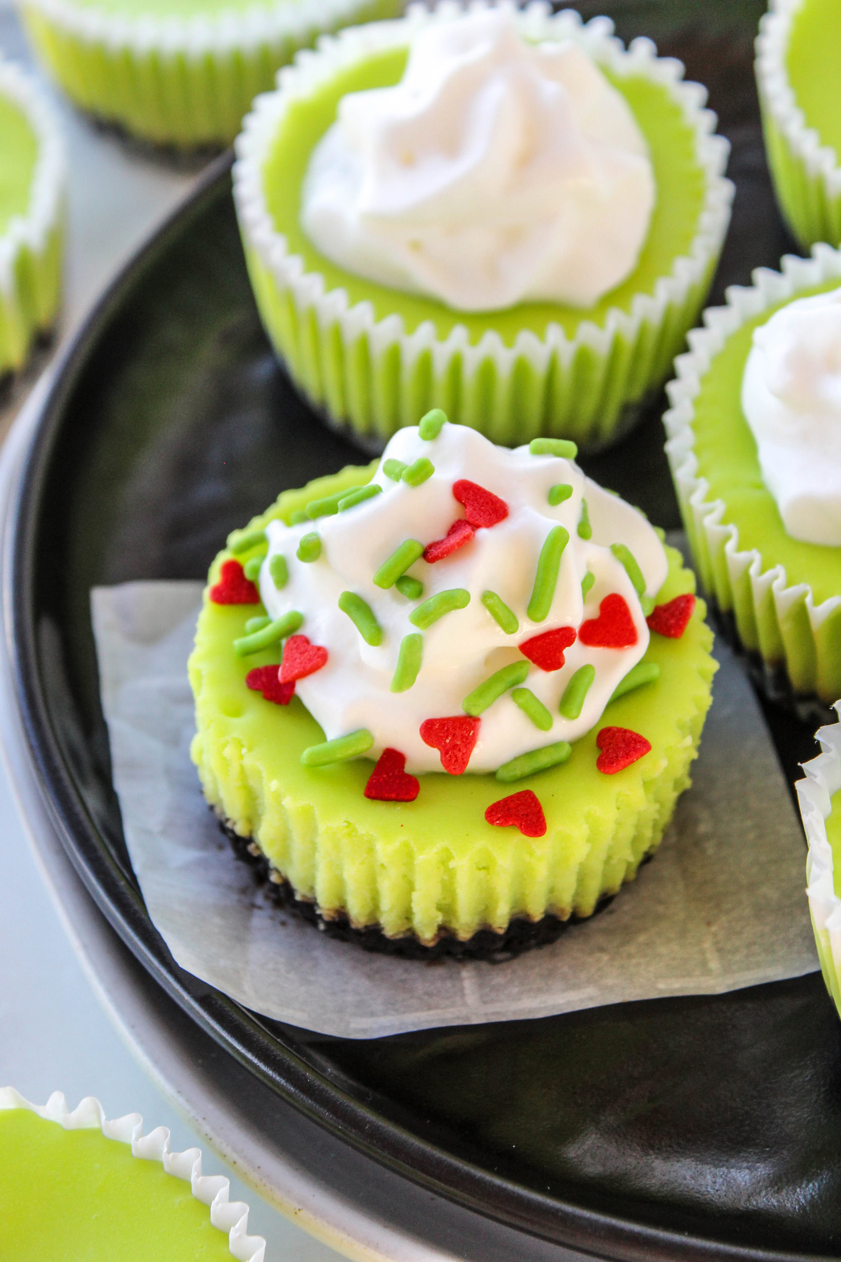 Whimsical Grinch Christmas cheesecakes in cupcake liners