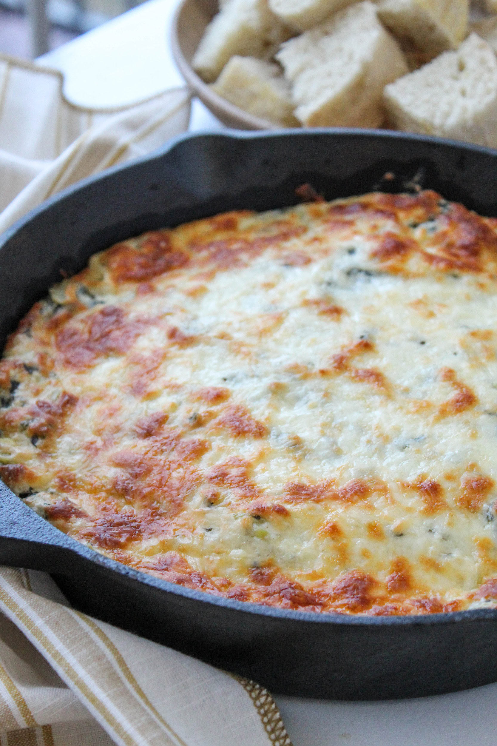 Hot spinach artichoke dip fresh out of the oven with browned cheese