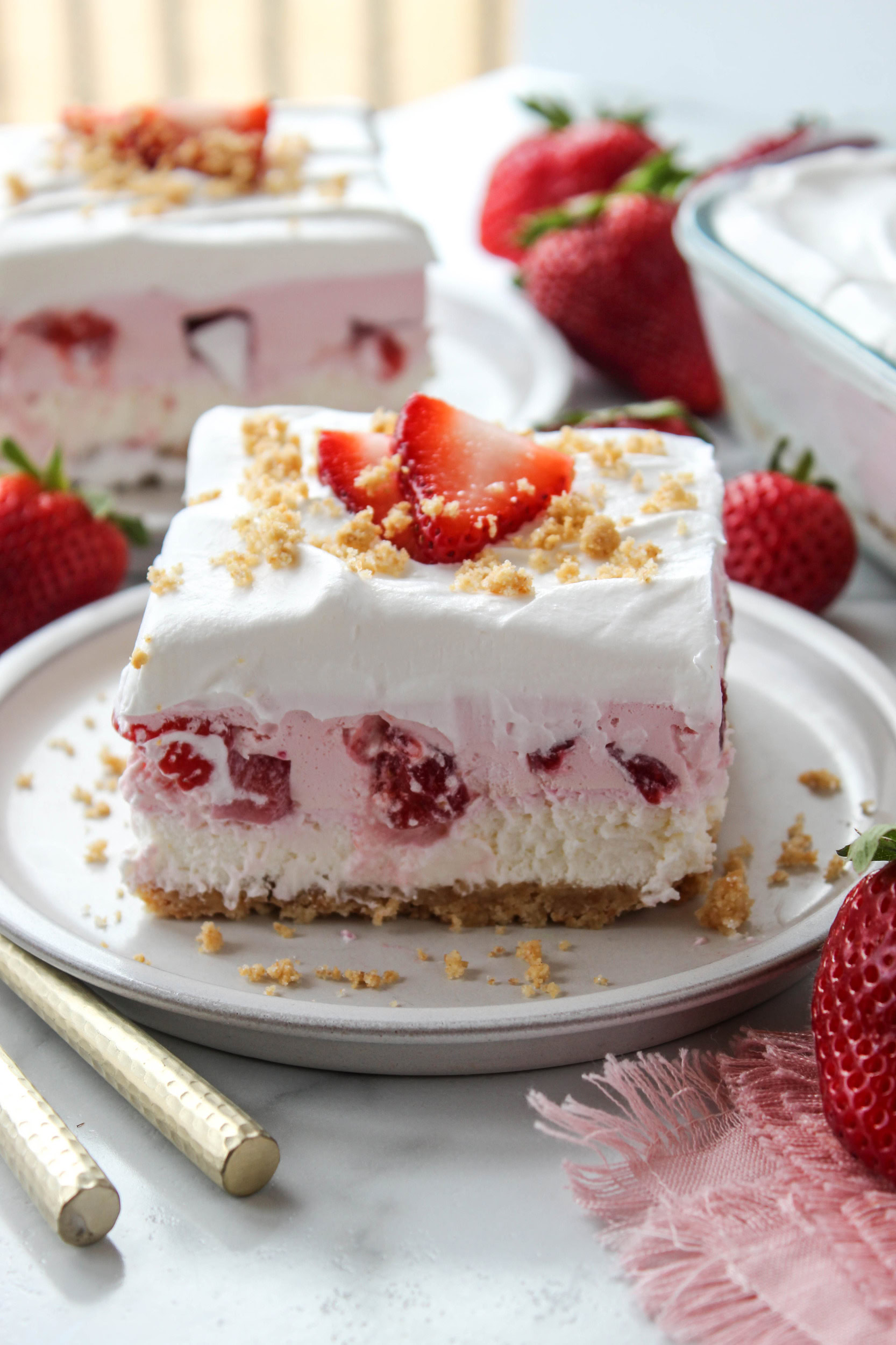 No-bake strawberry lasagna with creamy layers, strawberry topping, and graham cracker crust
