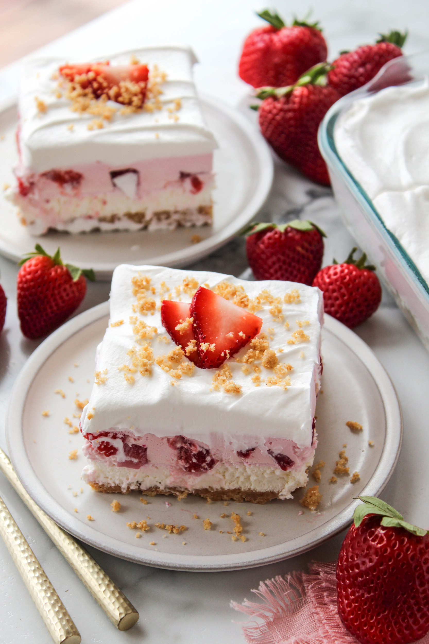 Slice of strawberry lasagna dessert served on a plate with creamy layers