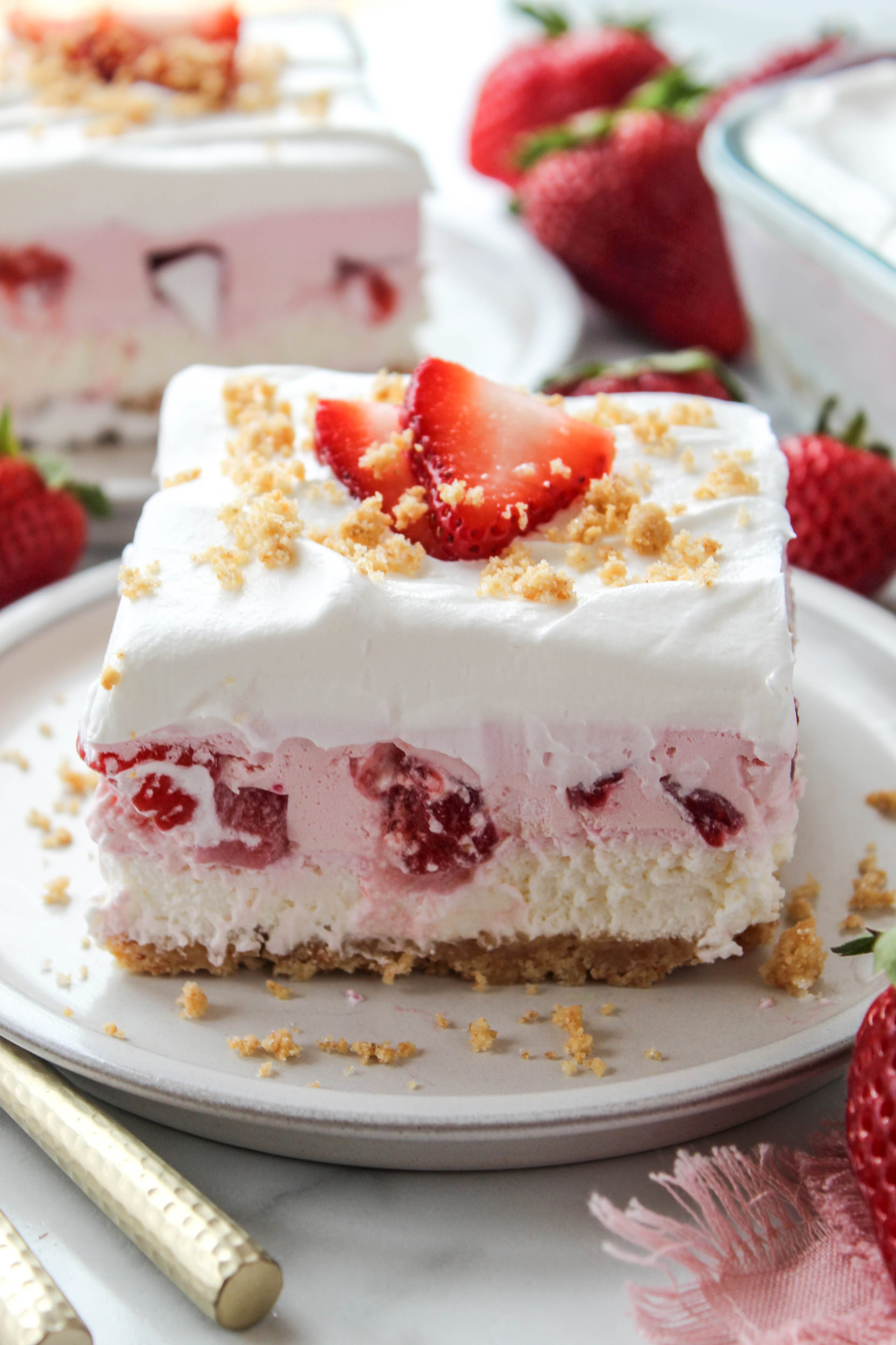 Close-up of strawberry lasagna showing layers of fluffy cream filling and sweet strawberry topping