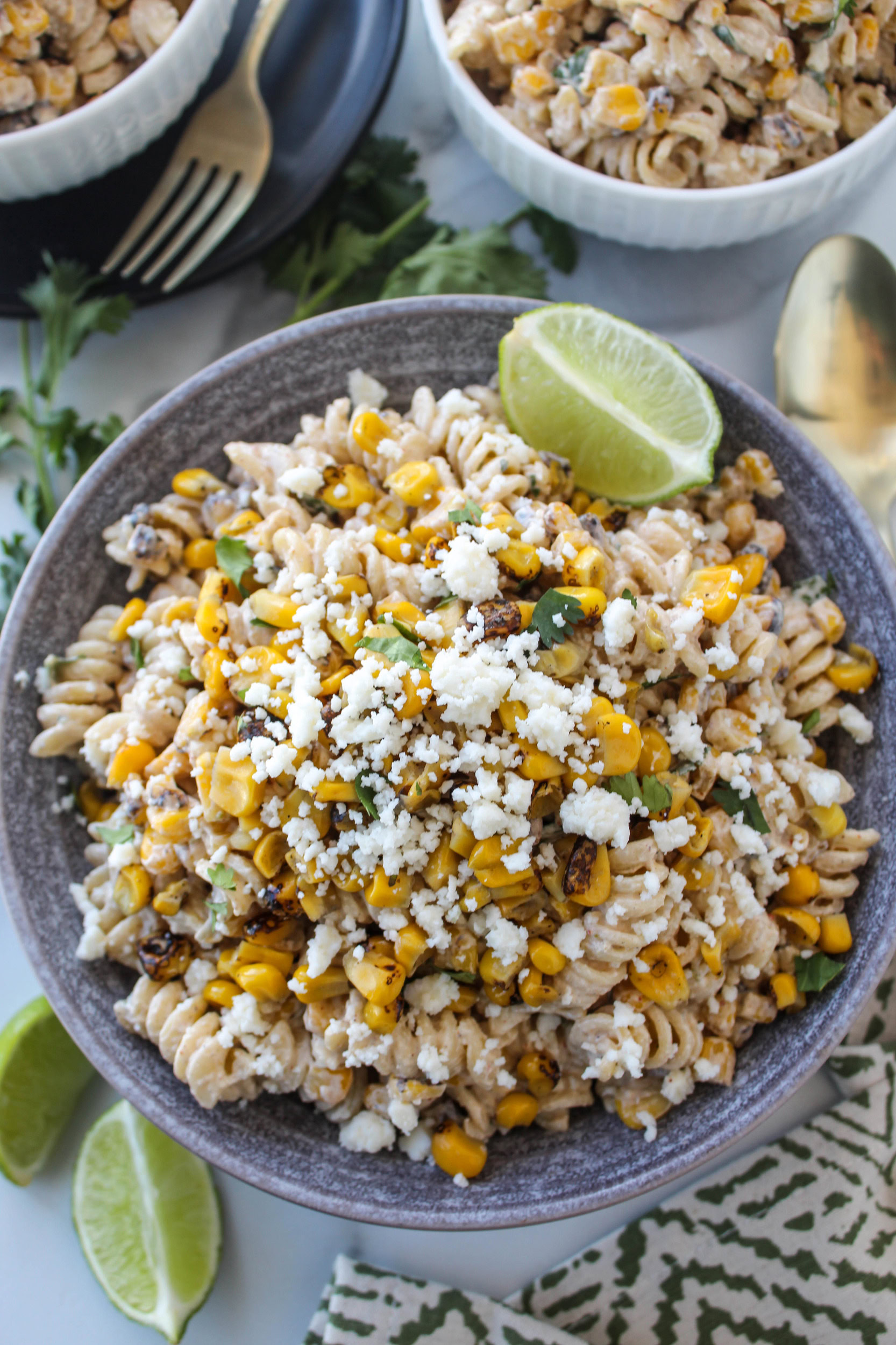 Creamy Mexican street corn pasta salad made with rotini, grilled corn, cilantro, and cheese