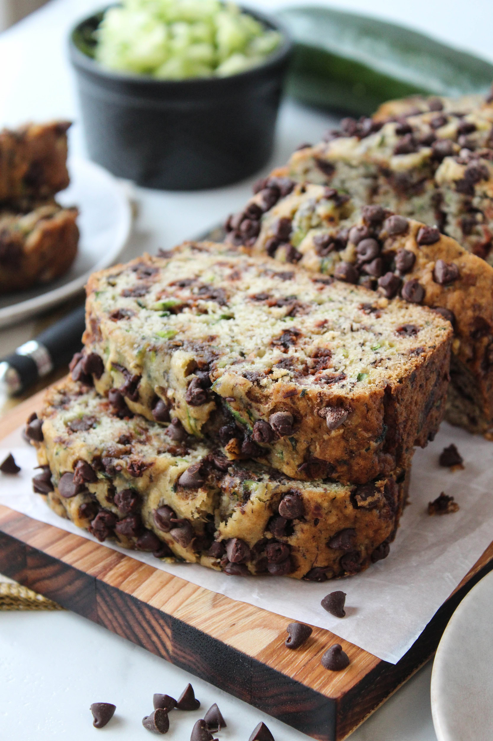 Chocolate chip zucchini bread loaf sliced on a cutting board