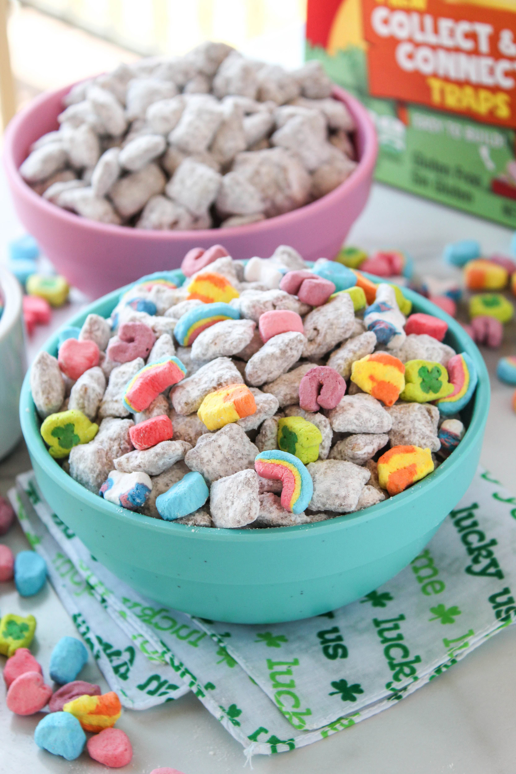 Lucky Charms puppy chow in a bowl with powdered sugar and marshmallows