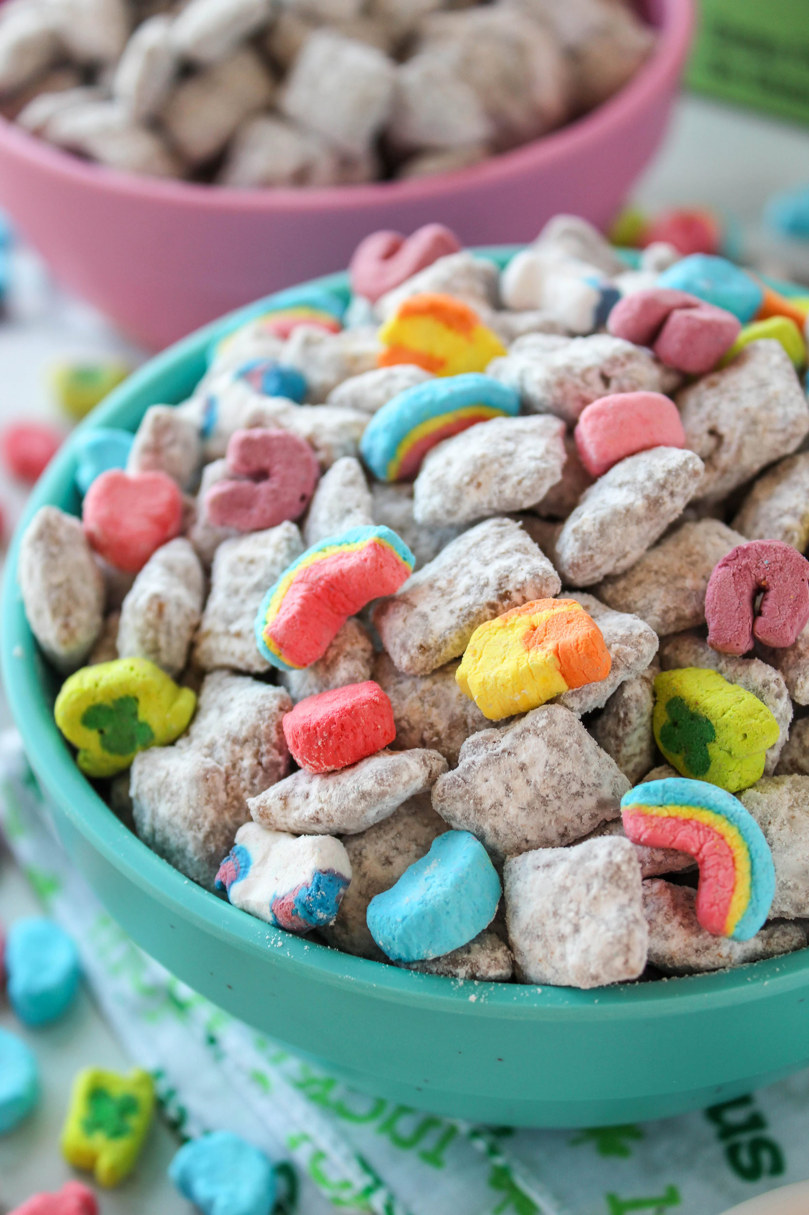 Sweet and crunchy Lucky Charms puppy chow snack mix with powdered sugar coating and marshmallow pieces