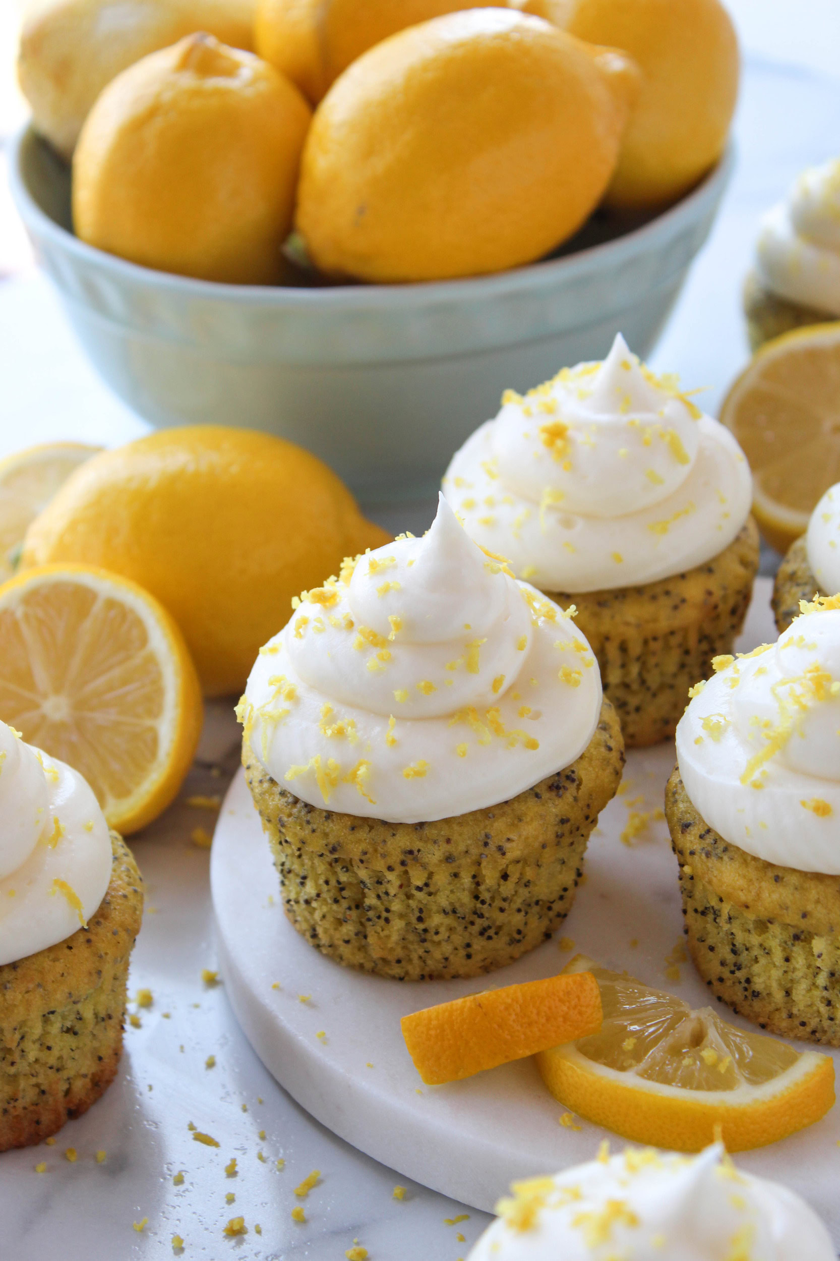Close‑up of lemon poppy seed cupcakes with cake mix, cream cheese frosting, and lemon zest