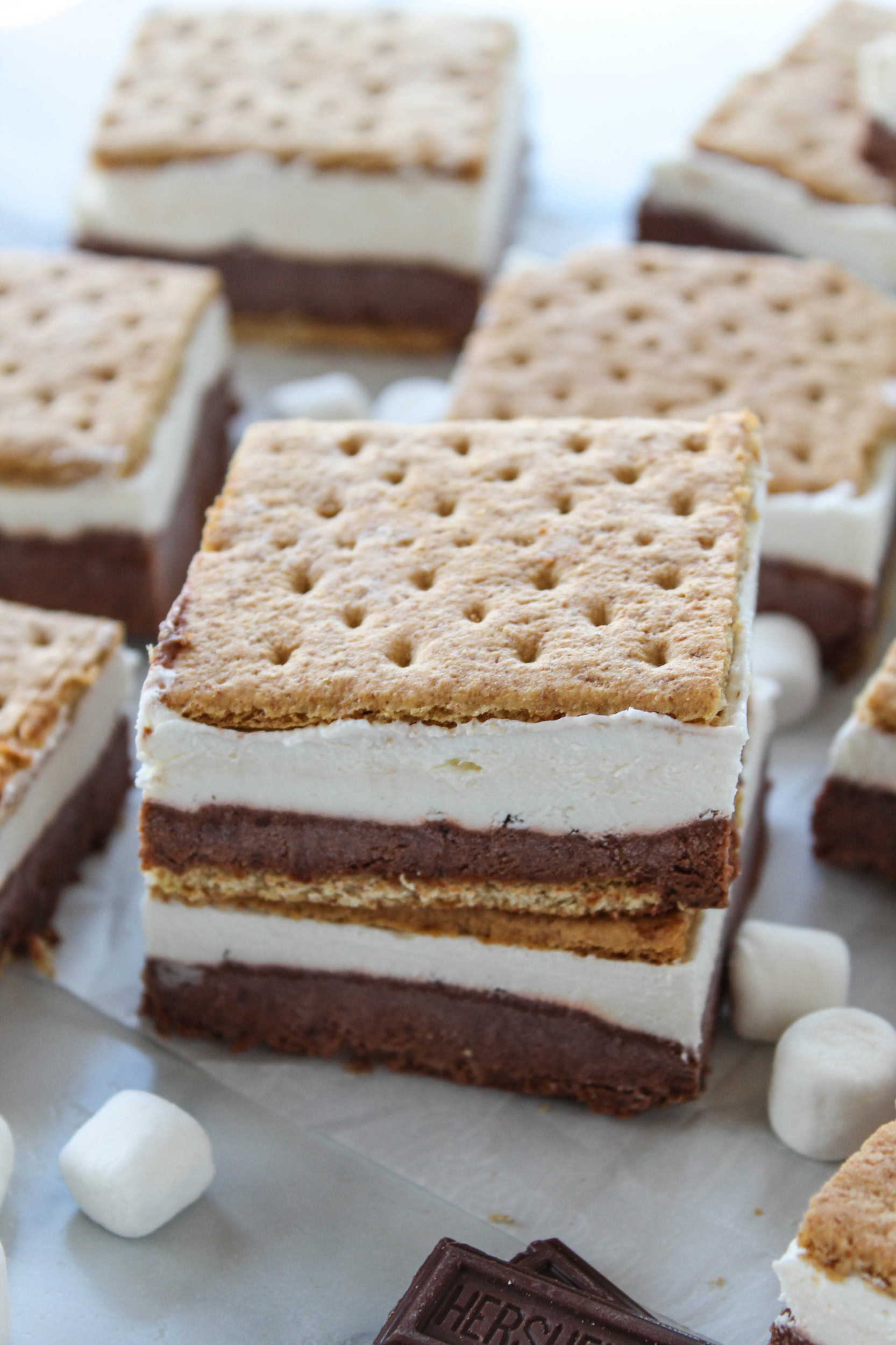 Frozen s’mores bars with chocolate and marshmallow layers between graham crackers, easy no-bake dessert