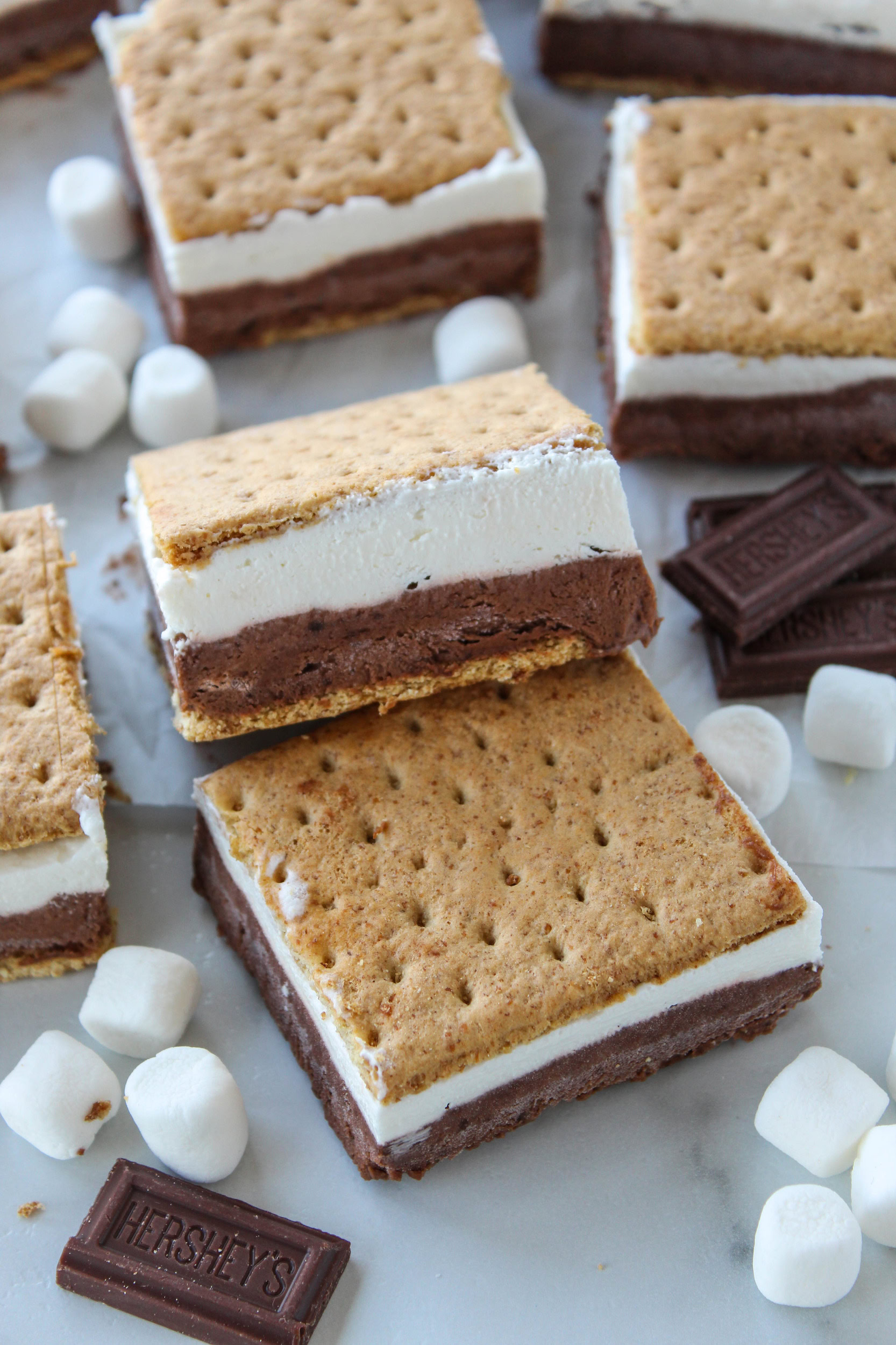 Frozen s’mores treat with chocolate and marshmallow filling, cut into bite-sized graham cracker bars