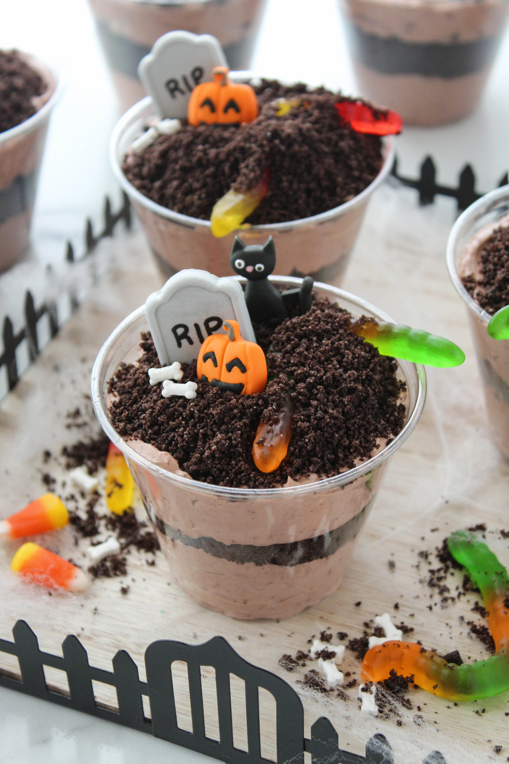 Spooky Halloween dirt pudding cups decorated with gummy worms
