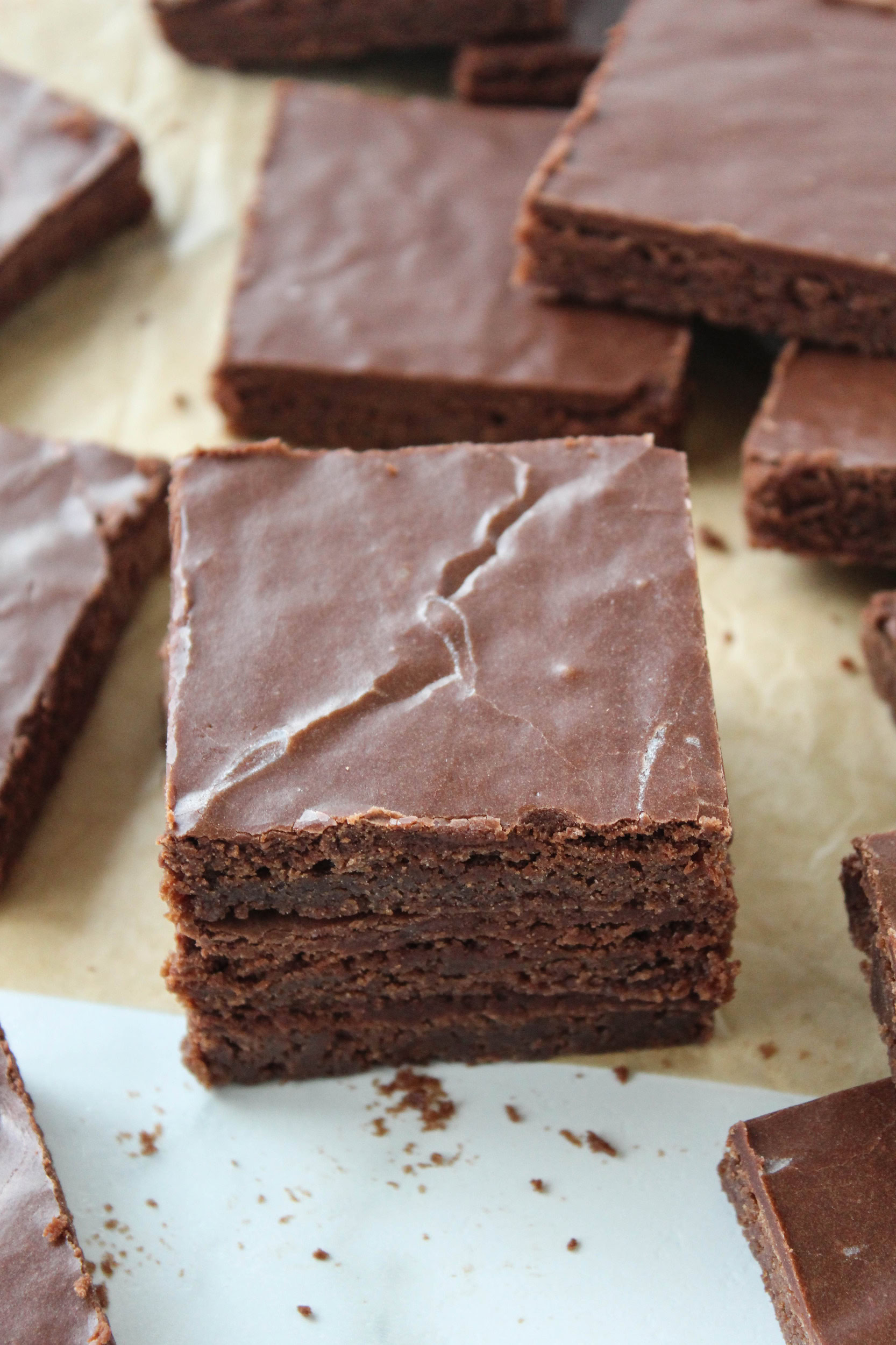 Sheet pan brownies with a smooth layer of chocolate frosting, cut into squares