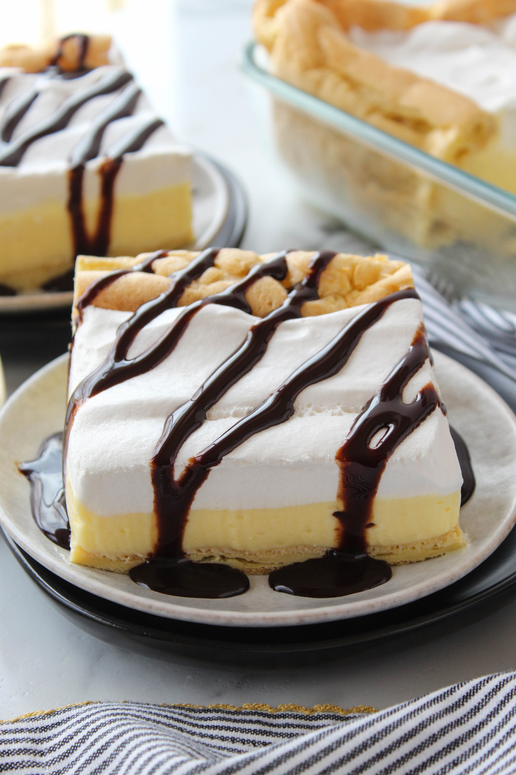 Classic cream puff cake with chocolate drizzle