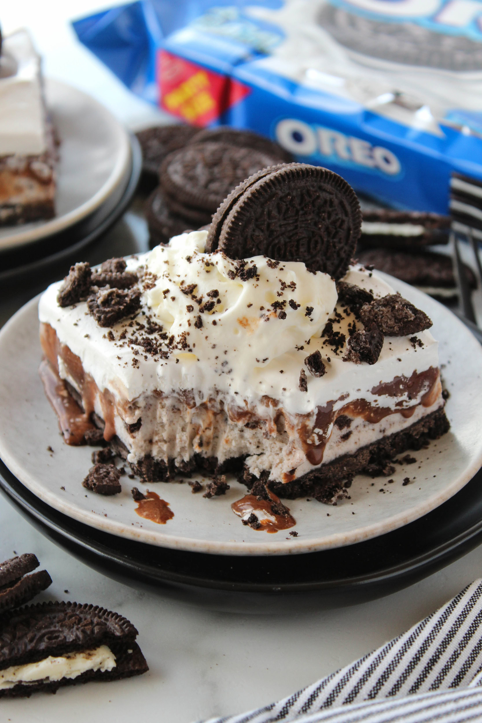 Cookies and cream ice cream cake with a crunchy Oreo base and chocolate fudge center