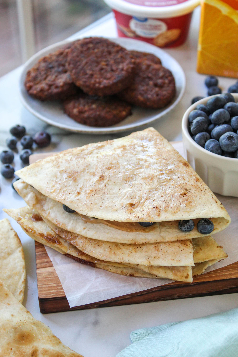 Golden-brown blueberry quesadilla arranged on a breakfast platter