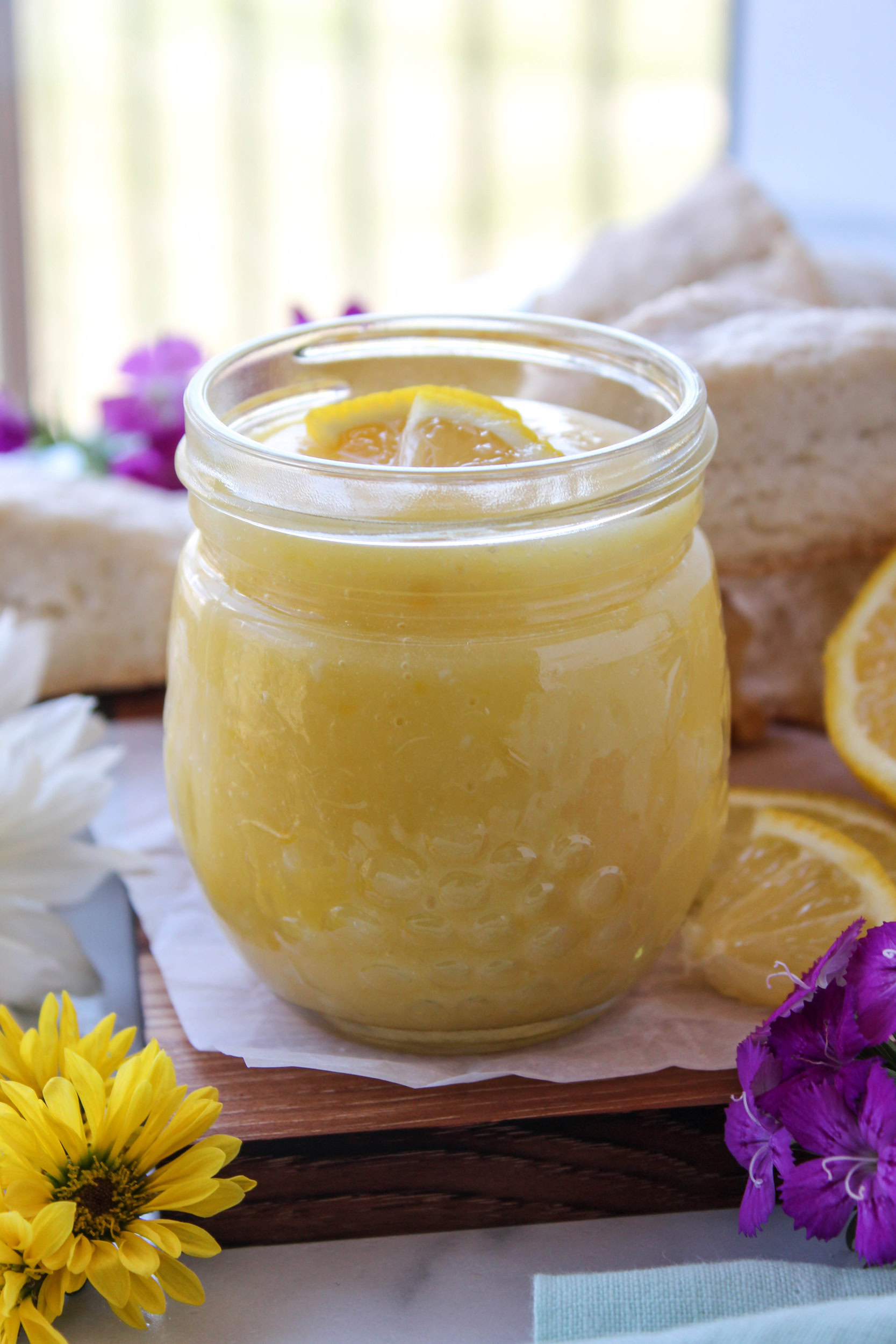 Jar of homemade lemon curd with lemon slices