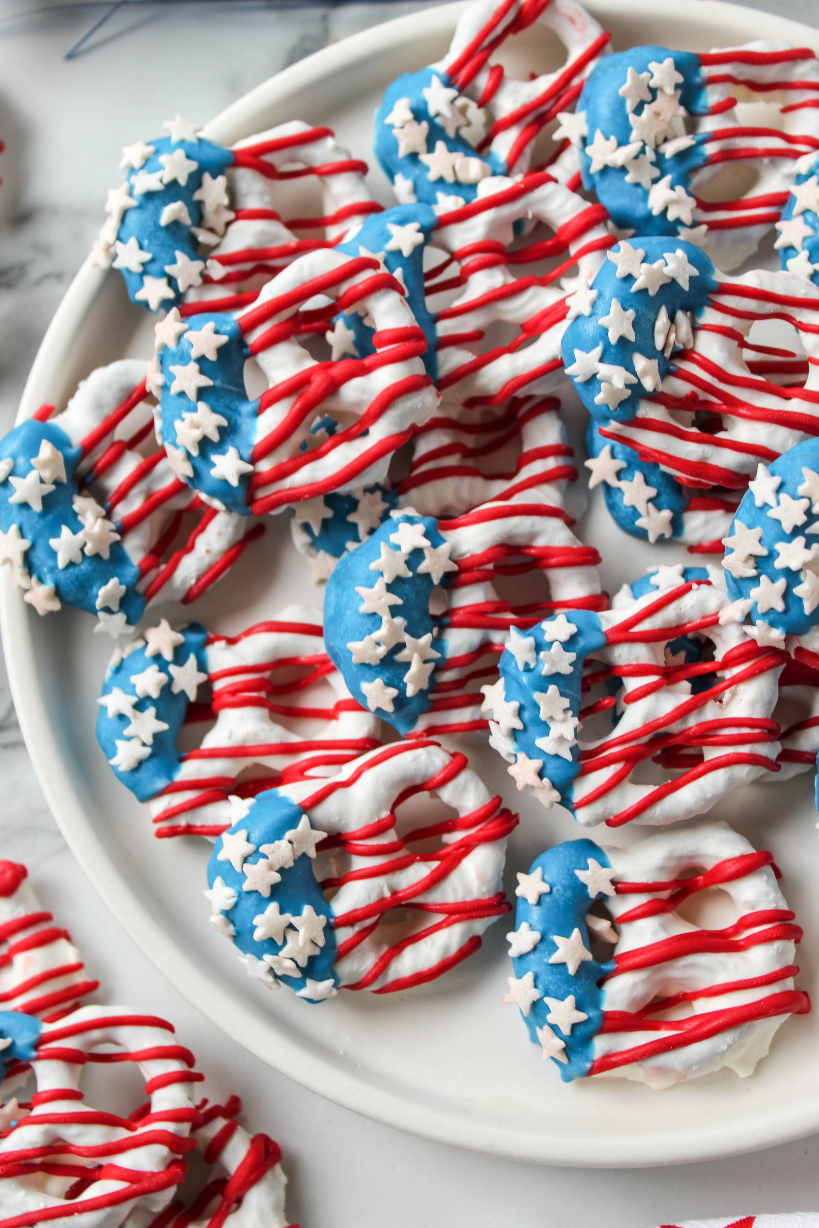 American flag pretzels on a white plate with patriotic red, white, and blue design