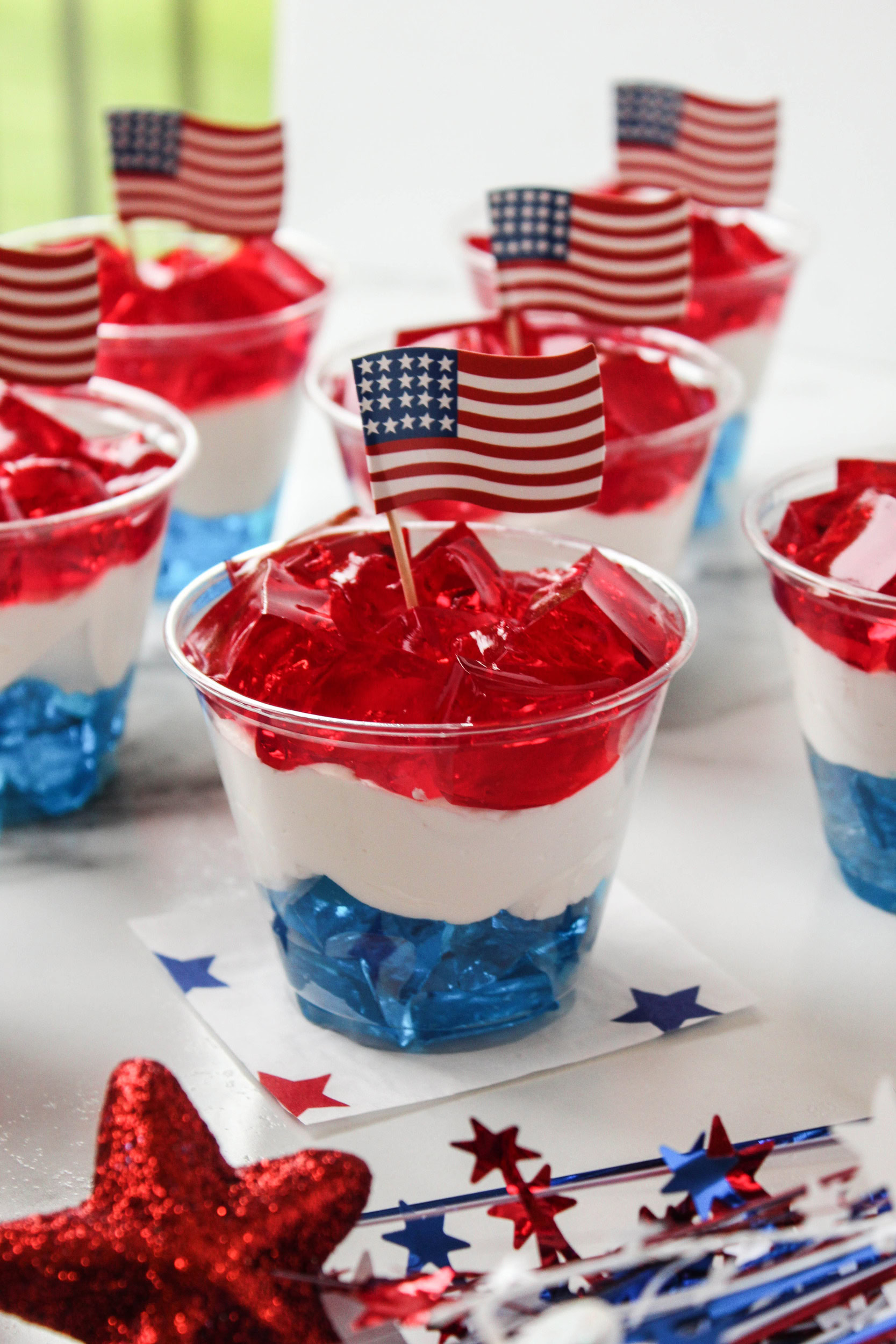 Patriotic Jell‑O cups with red, white, and blue layers in clear cups