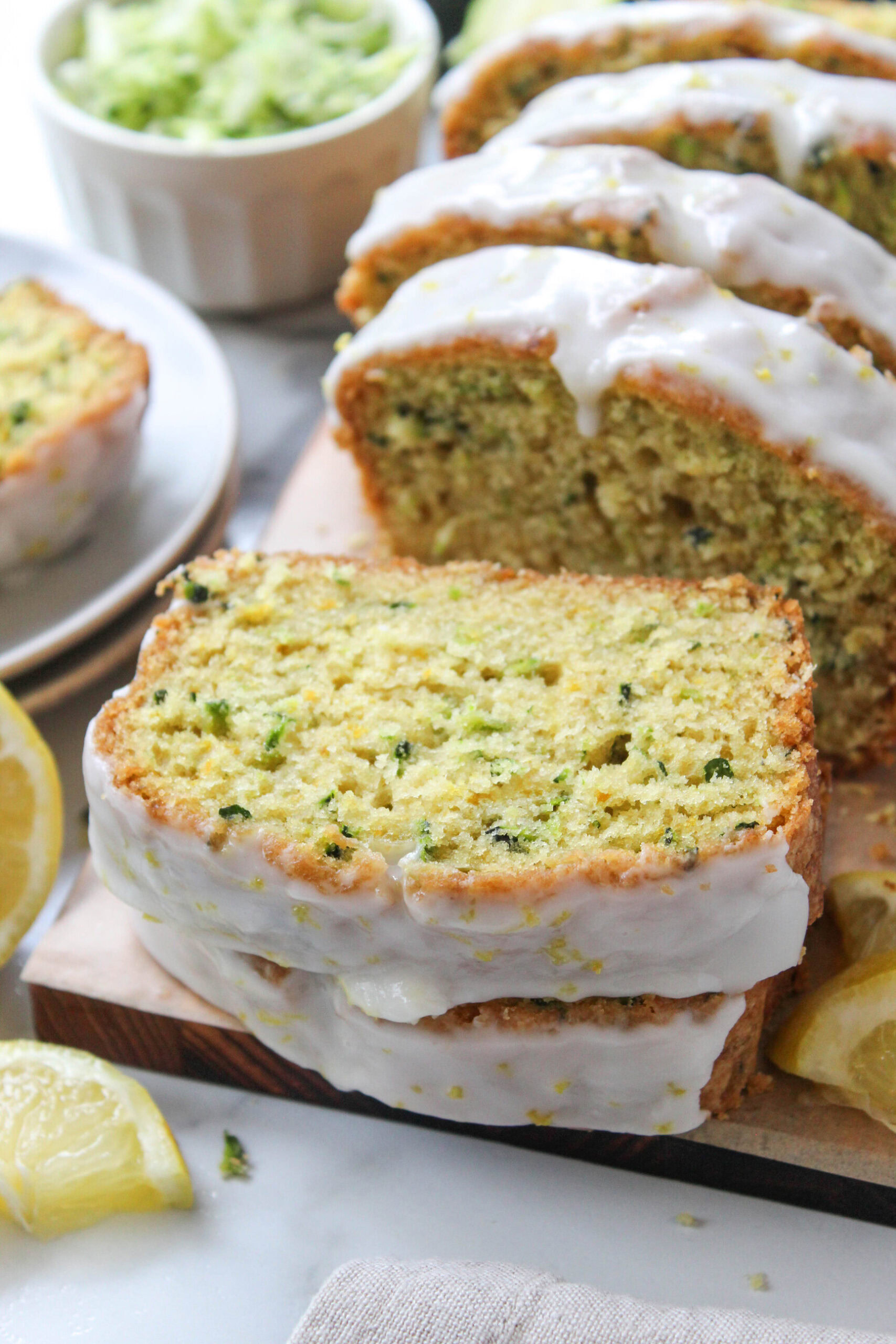 Golden zucchini bread with tangy lemon icing and a moist, fluffy interior