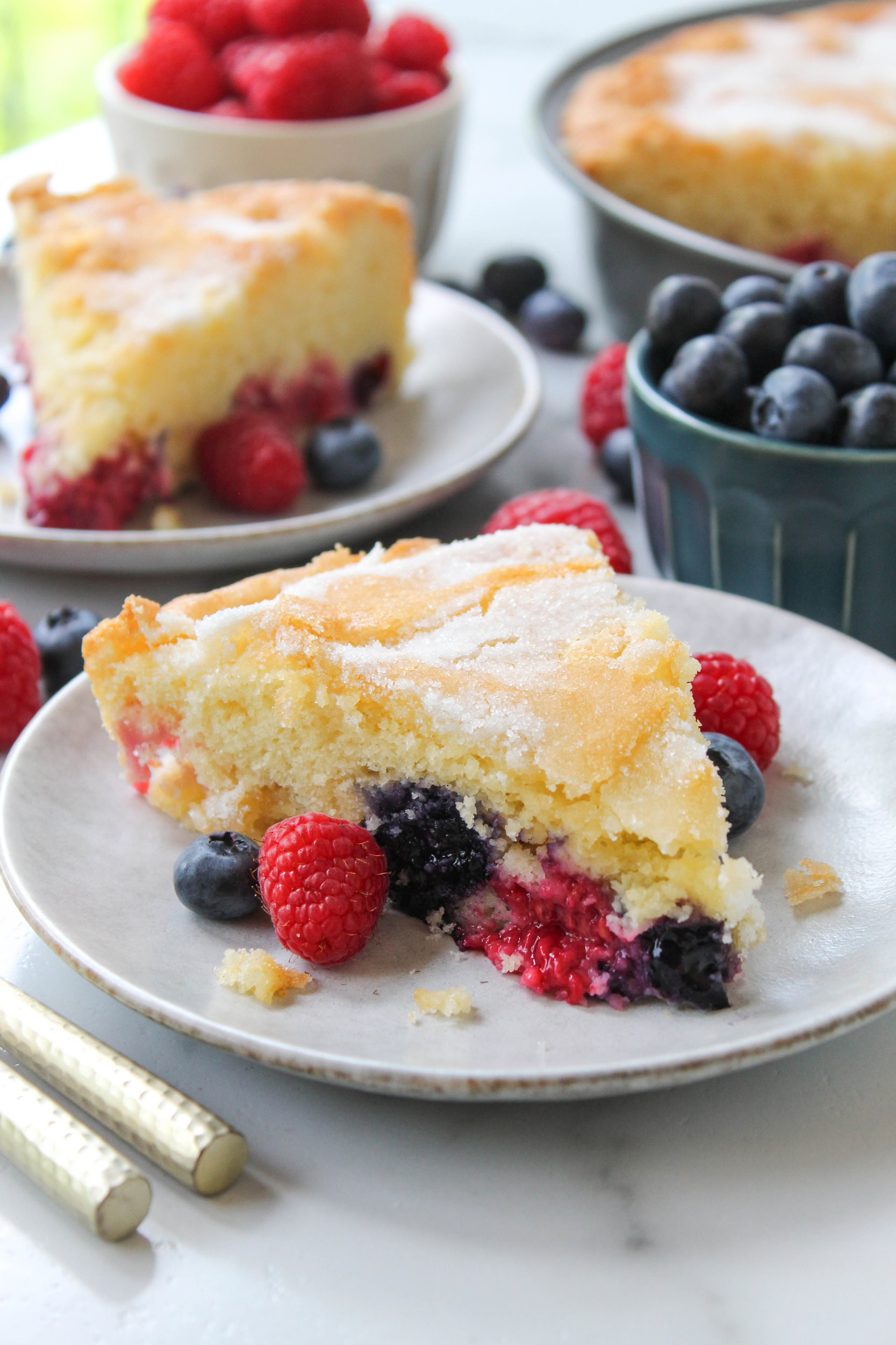 close up of moist mixed berry cake slice with tender crumb