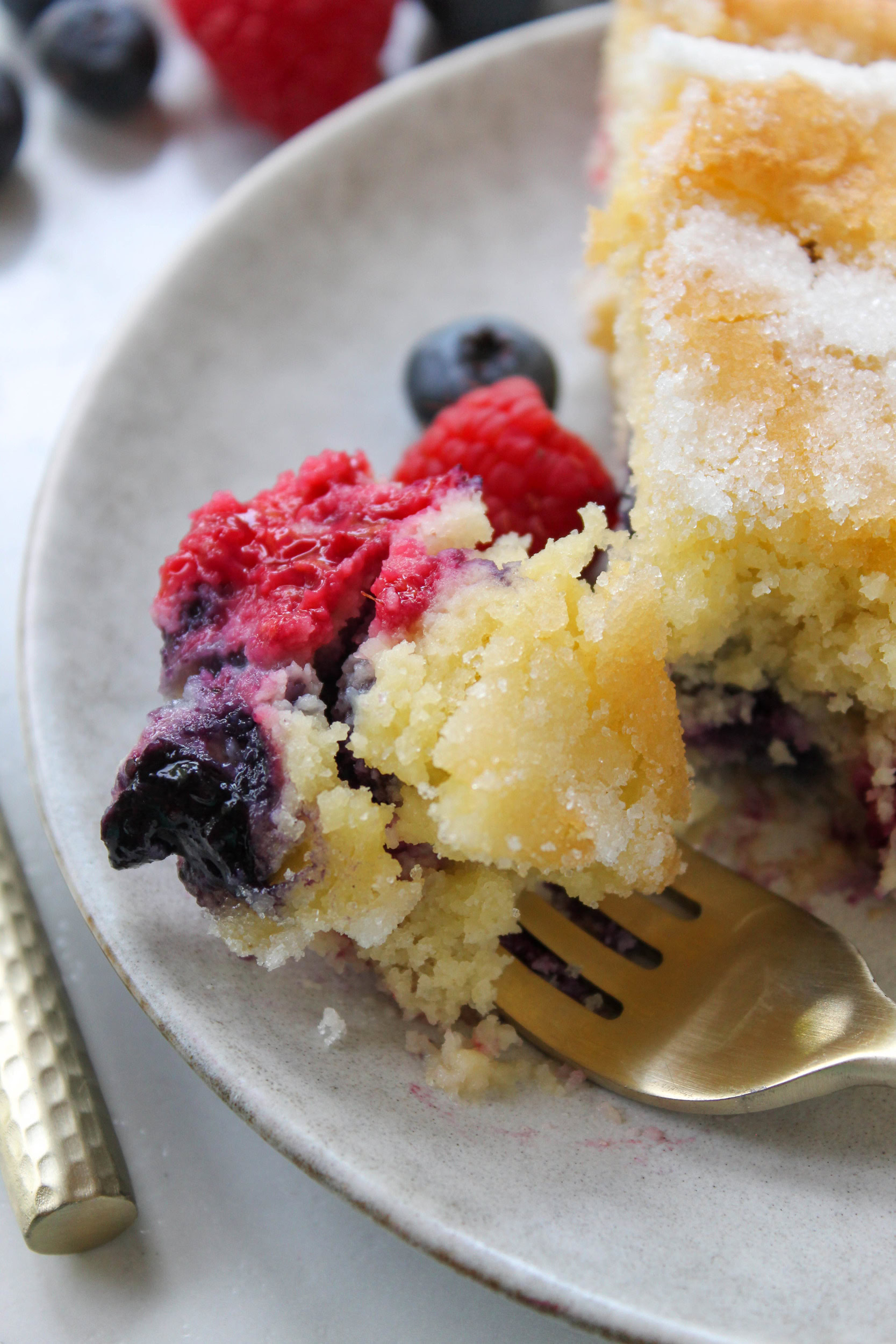 mixed berry cake slice served on plate