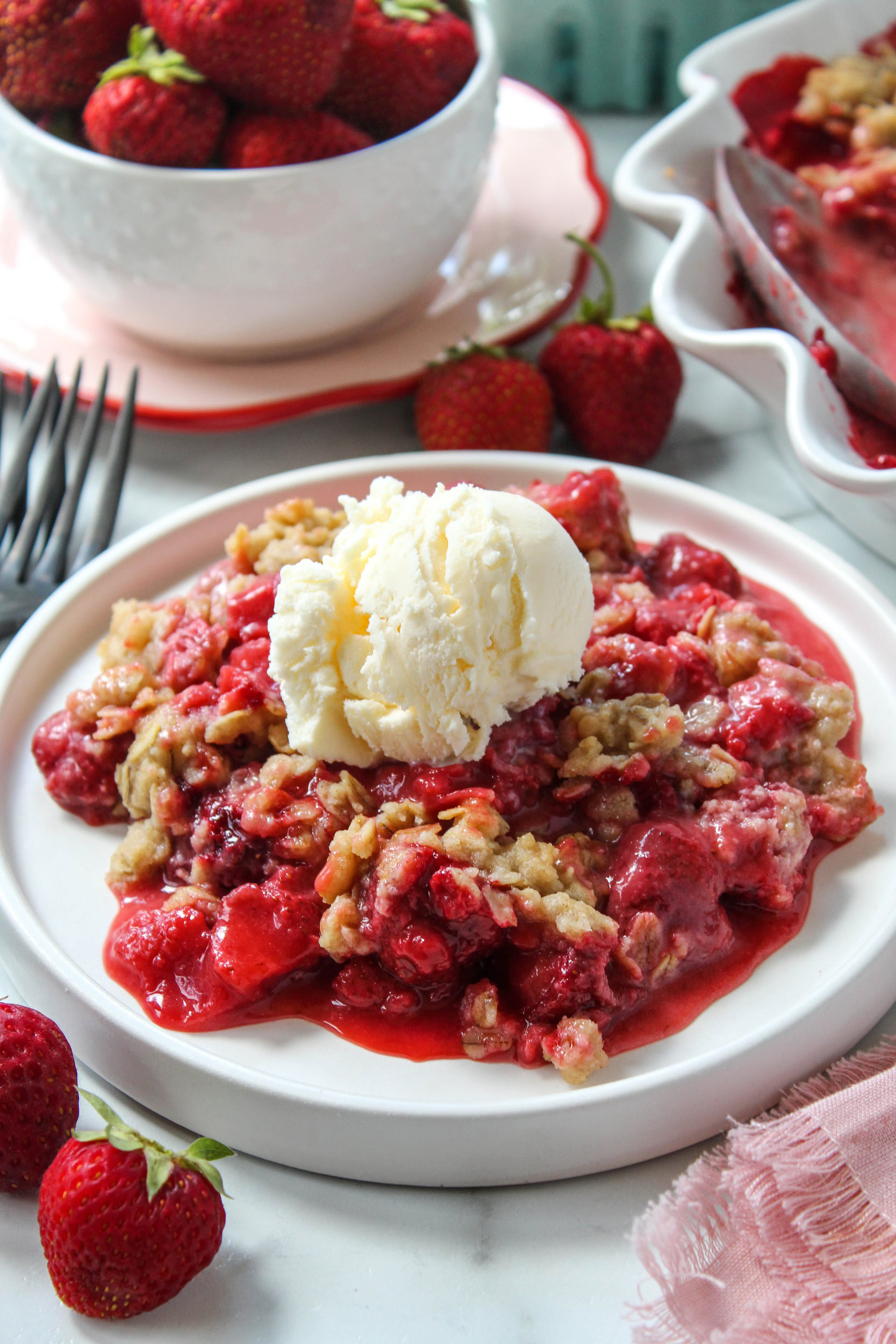 Baked strawberry crisp with a golden oat topping and bubbling strawberry filling