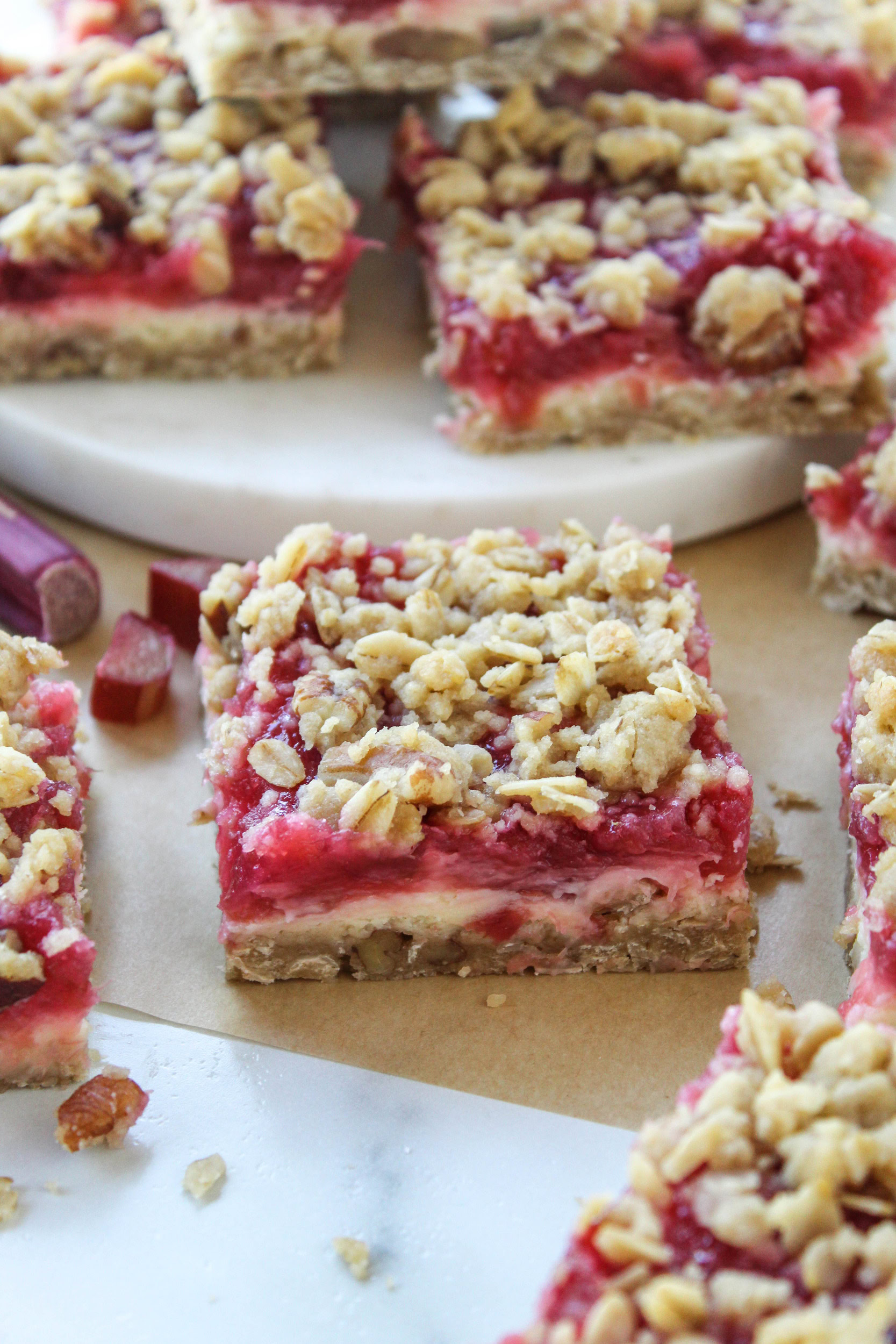 Homemade rhubarb cheesecake bars with creamy filling and tangy rhubarb topping
