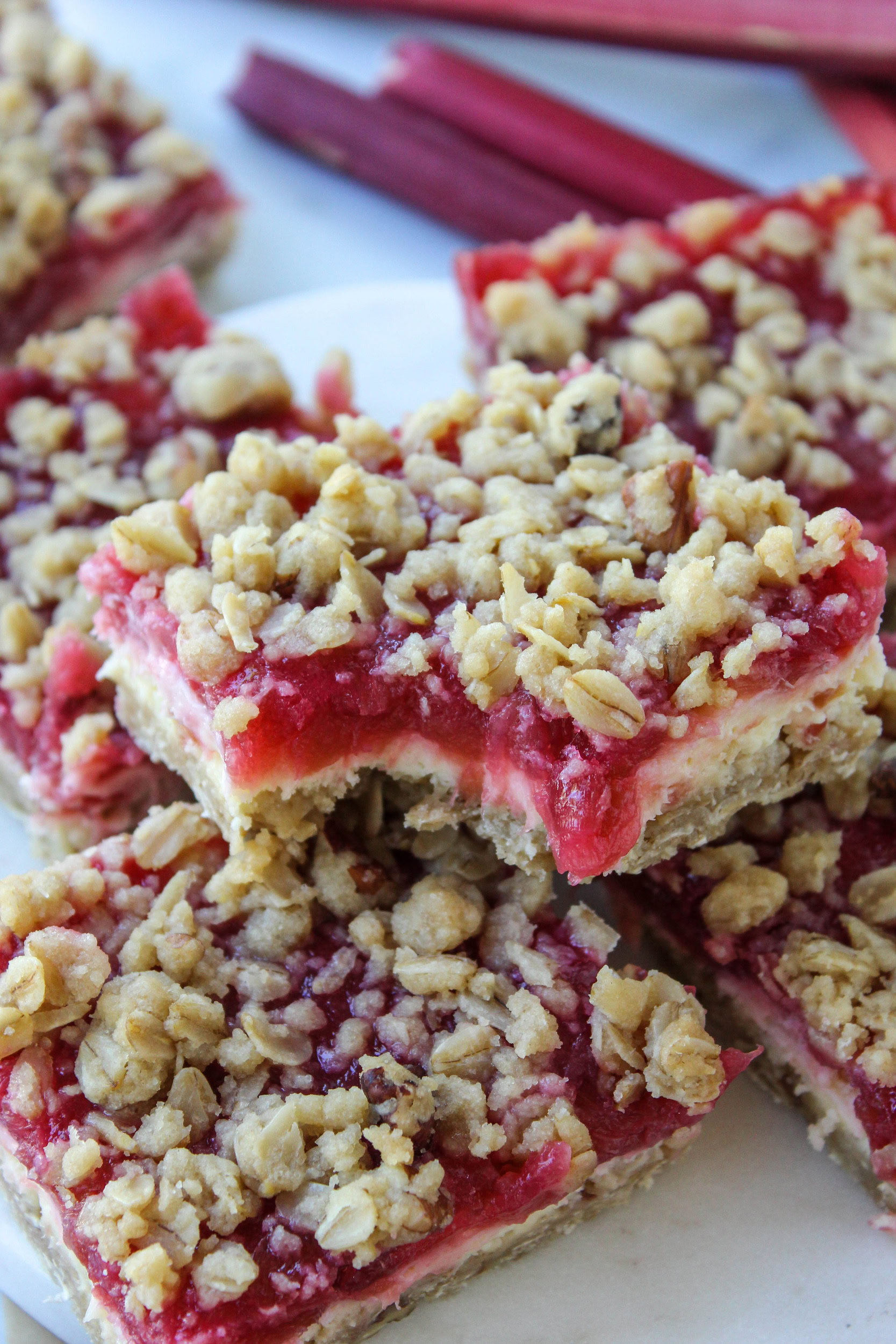 Cheesecake bars arranged on a tray with visible creamy layers and fruit topping