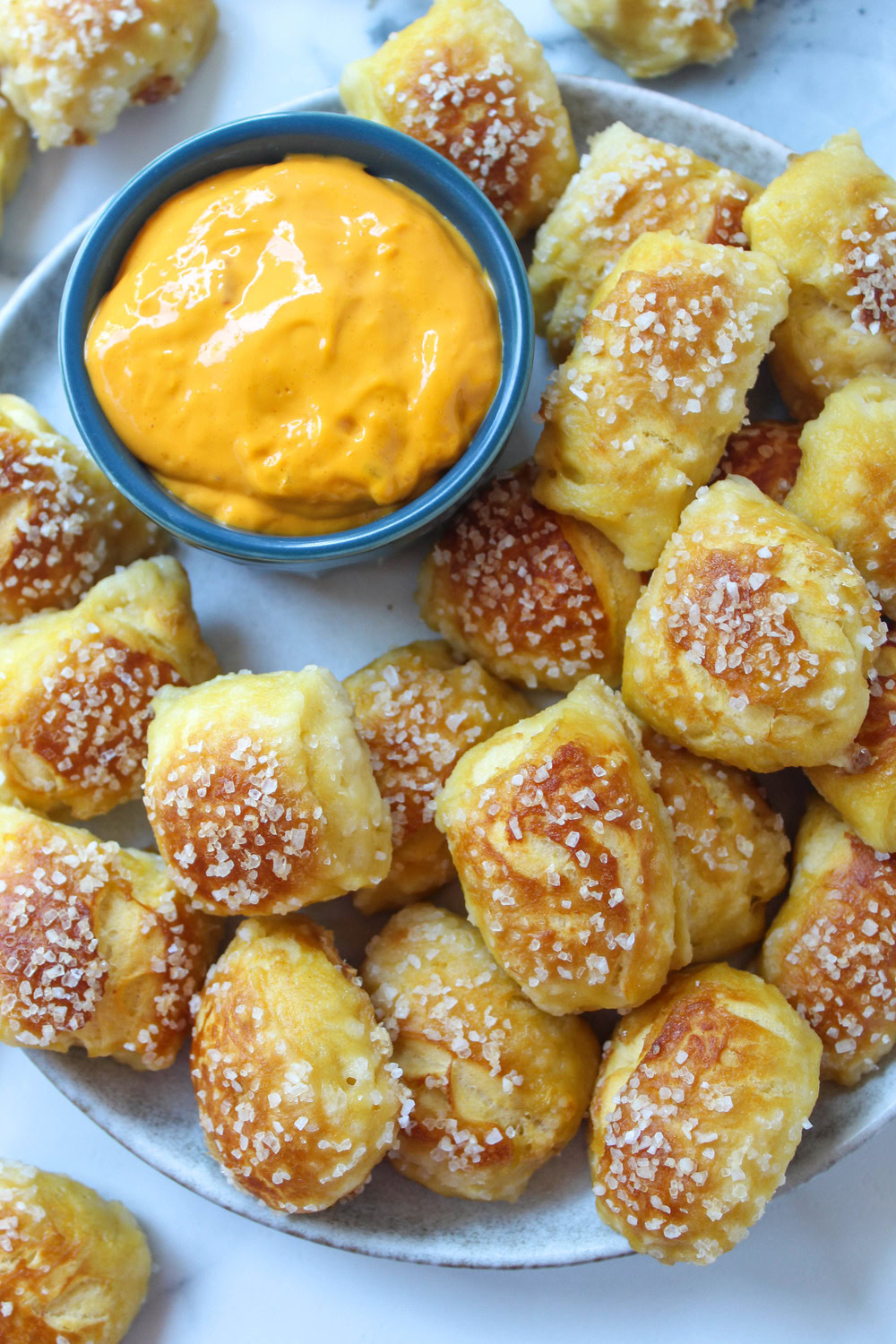 Golden brown biscuit dough pretzel bites sprinkled with coarse salt