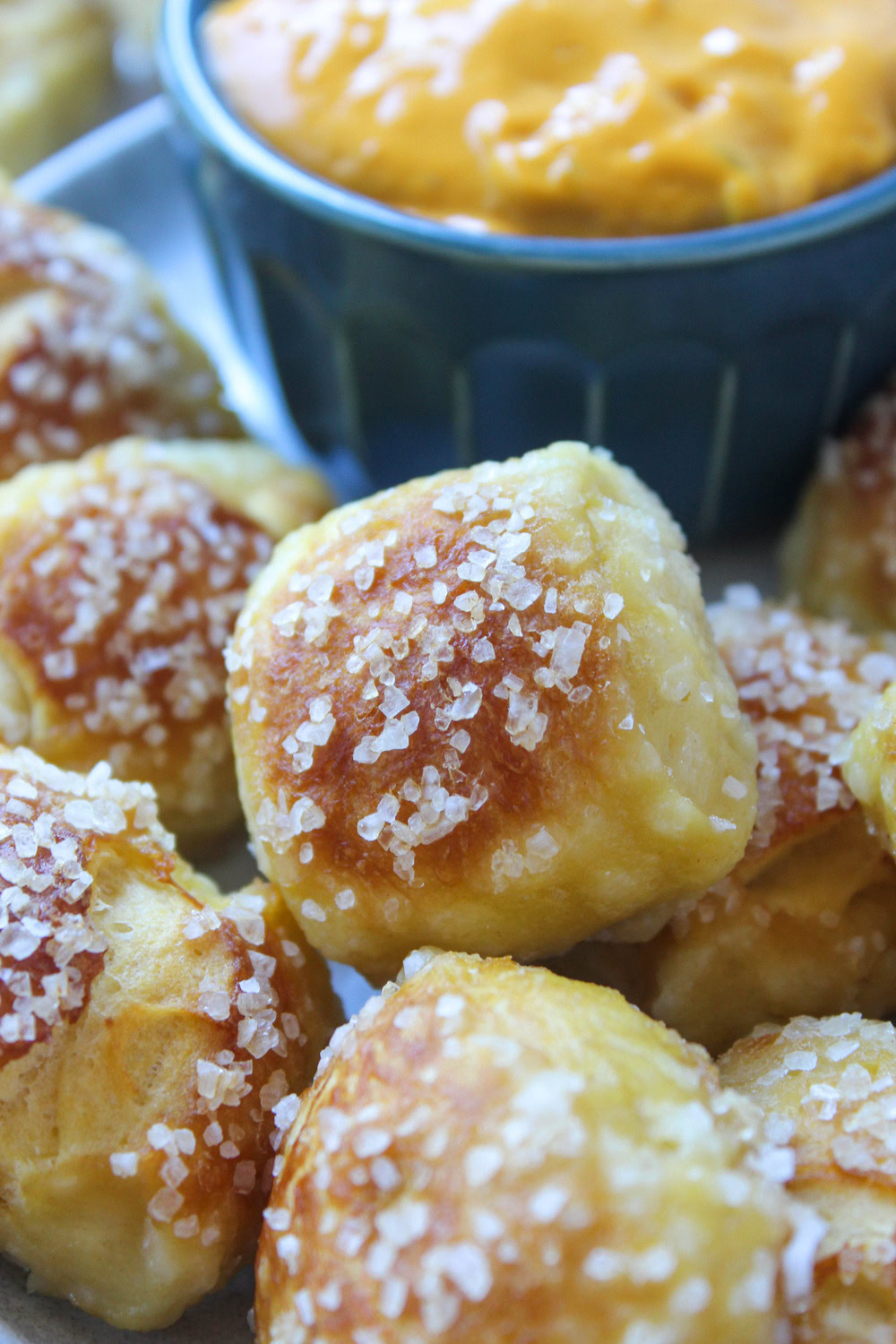 Warm pretzel bites made with biscuit dough served with cheese dip