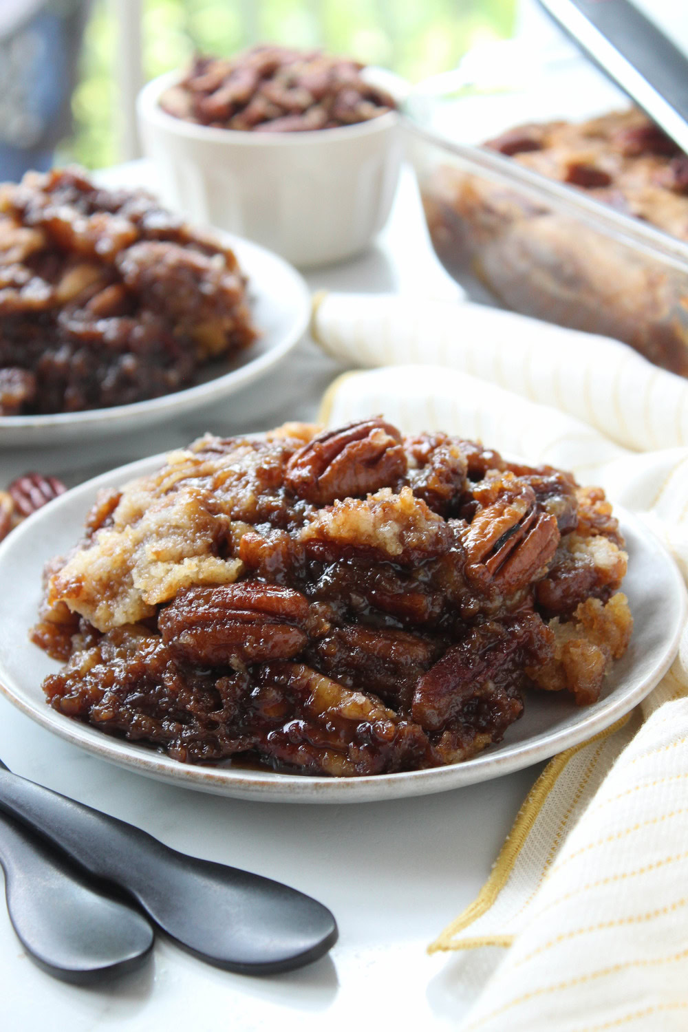 Slice of pecan pie dump cake served warm