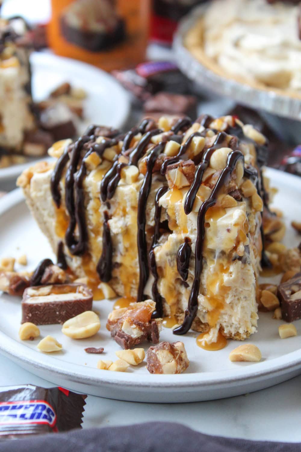 Rich no-bake Snickers pie featuring layers of chocolate, caramel, and peanut filling