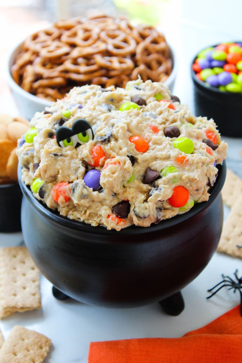 Halloween monster cookie dough dip decorated with candy eyes and colorful sprinkles