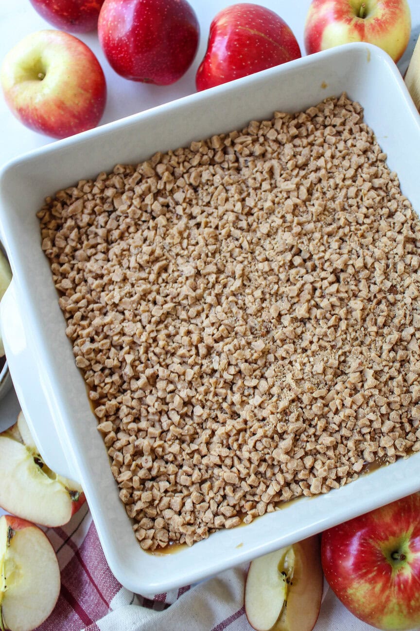 Caramel apple dip topped with crushed toffee and served with sliced apples