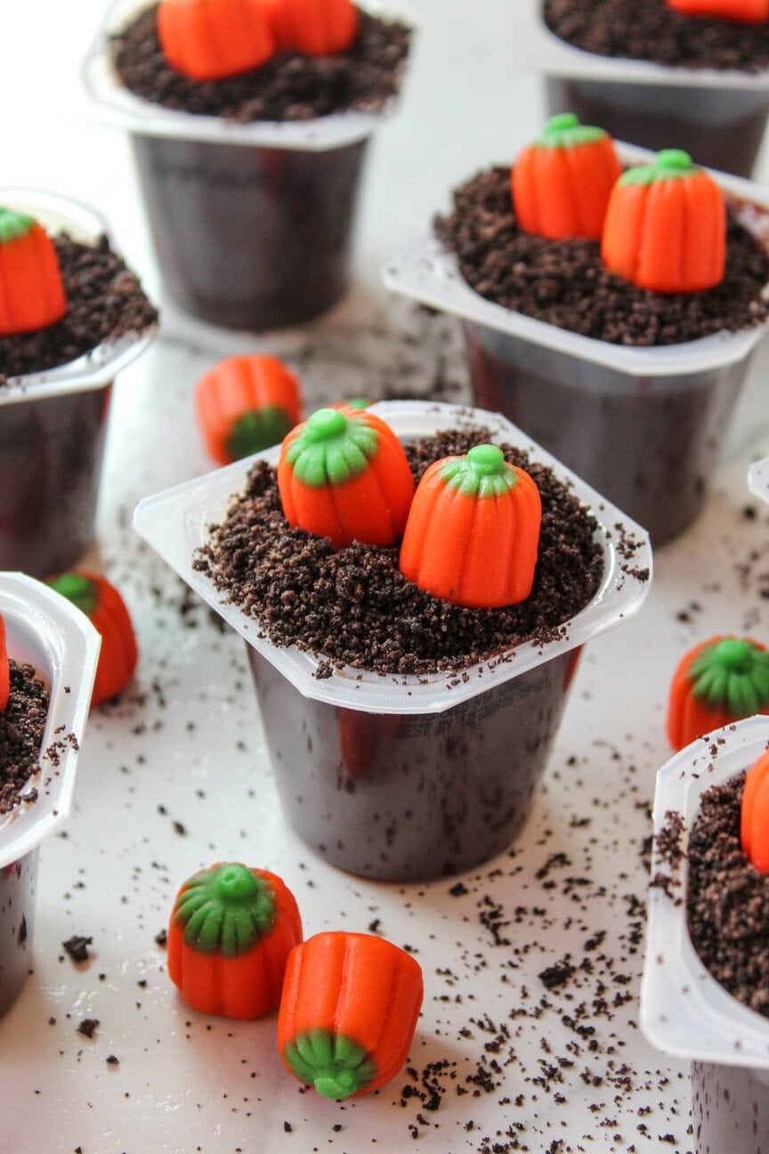 Mini pumpkin patch dirt cups with crushed Oreos and candy pumpkins