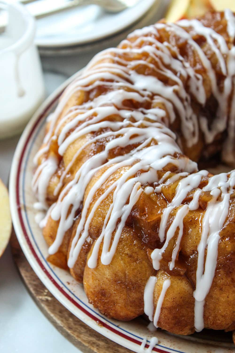 Golden brown apple fritter monkey bread drizzled with icing